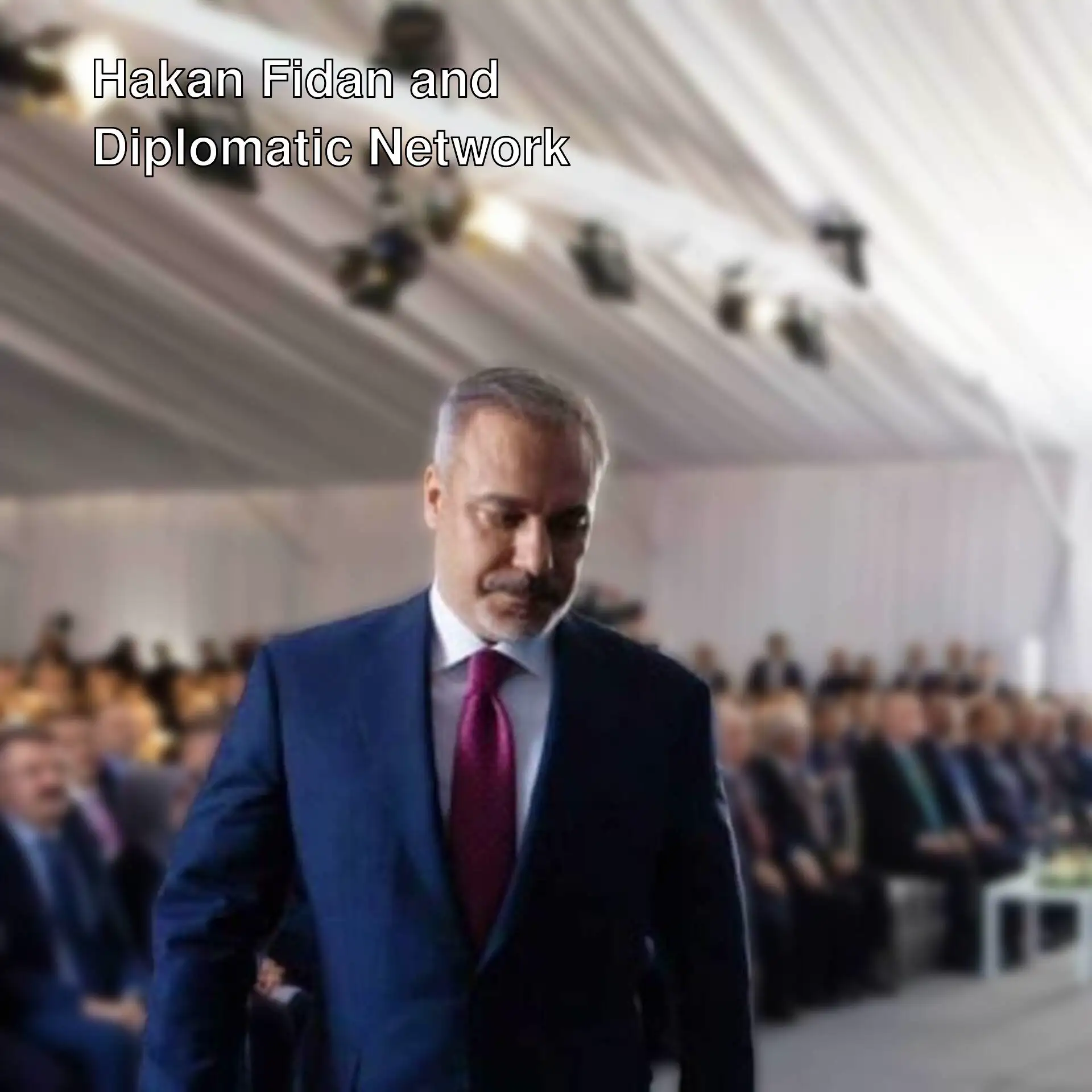 Foreign Minister Hakan Fidan walking on stage.