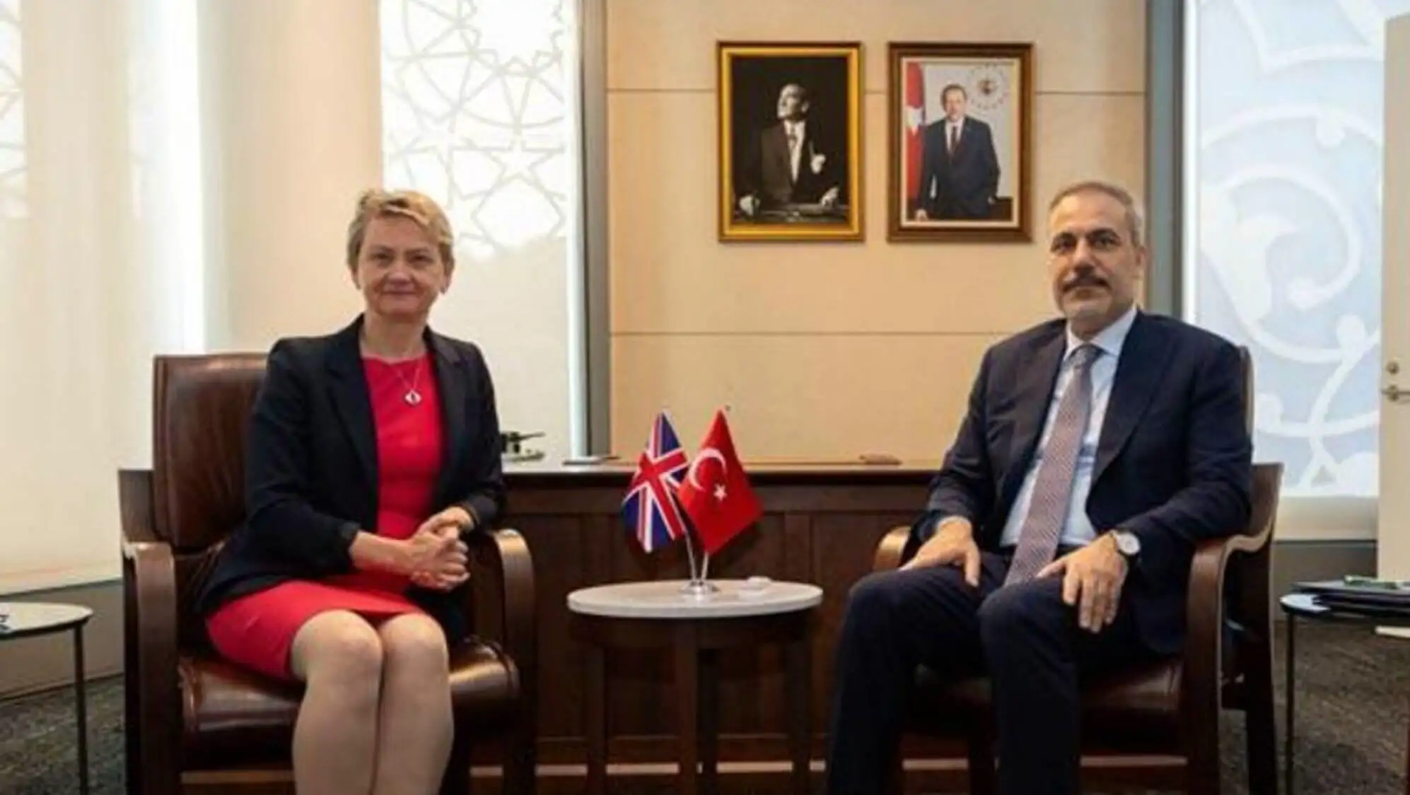 Foreign Minister Hakan Fidan and British Foreign Secretary Yvette Cooper sitting together.
