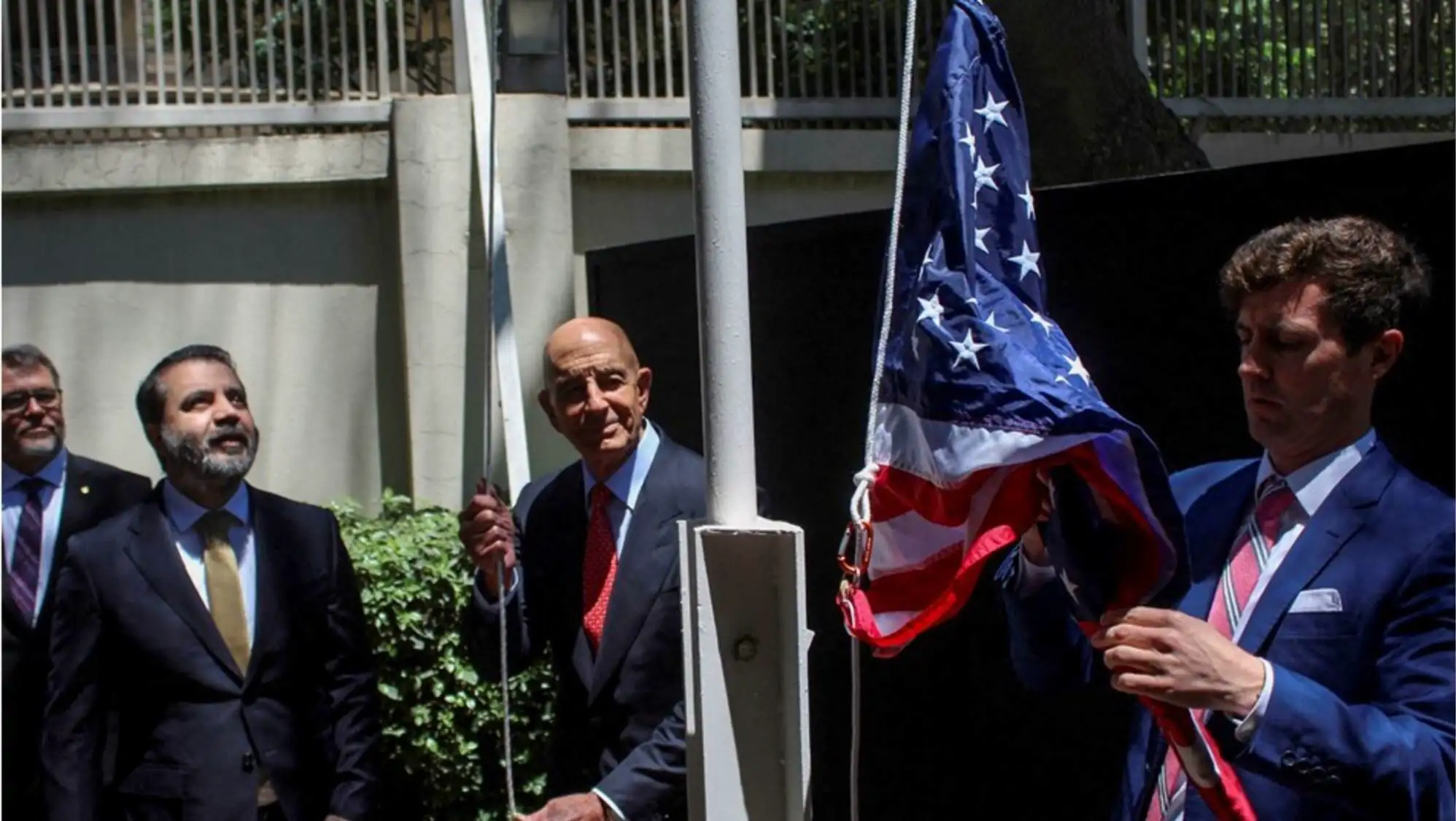 A group of men holding a flag.