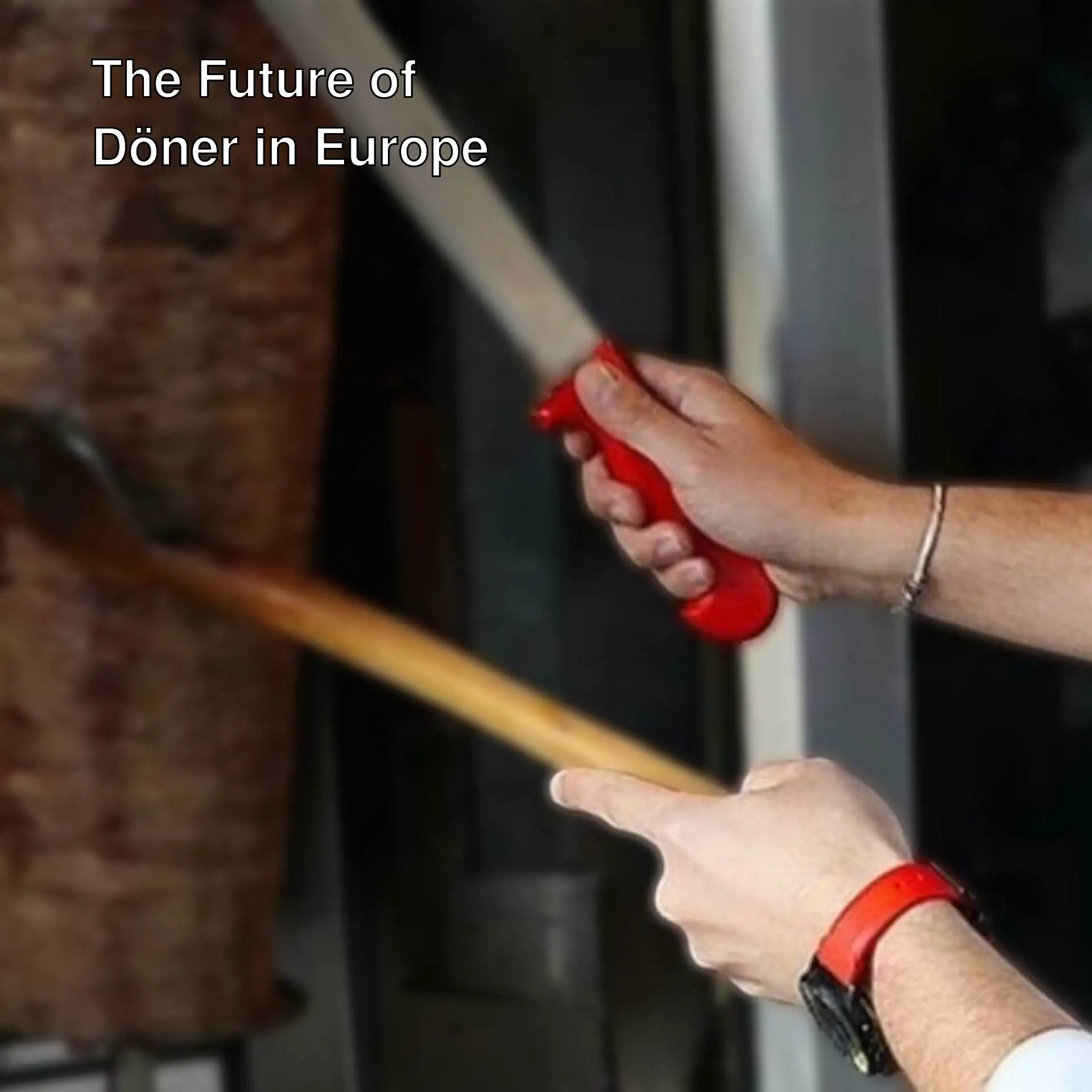 A person holding a knife and cutting meat.