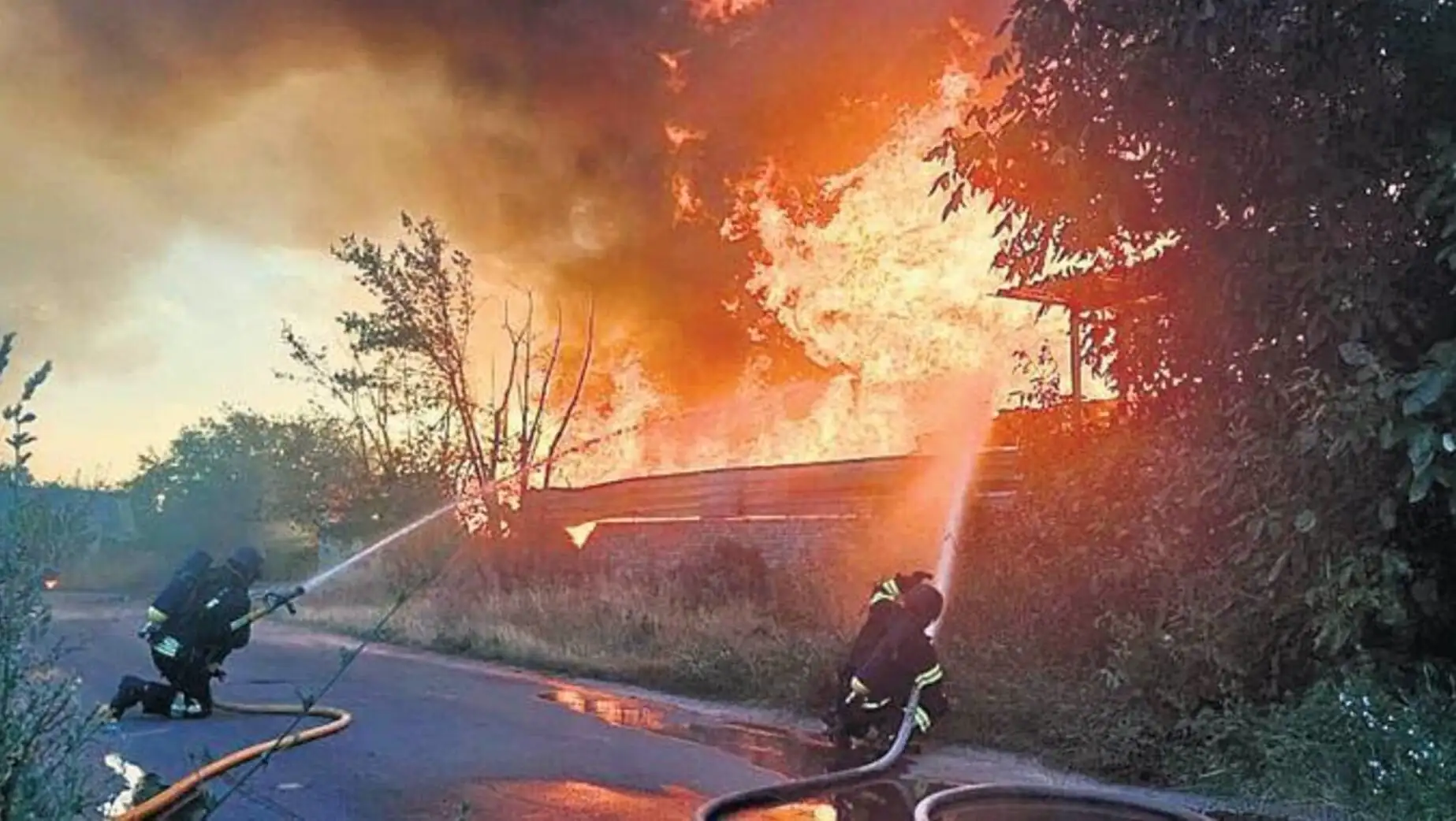 A firefighter spraying water on a fire.