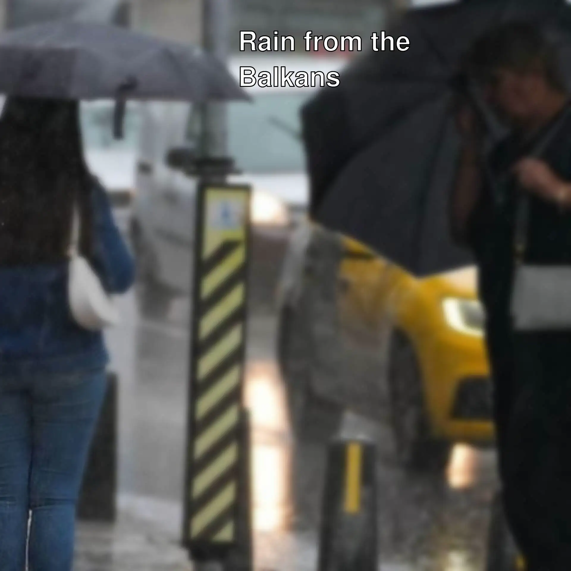 Two women holding umbrellas in the rain in Istanbul.
