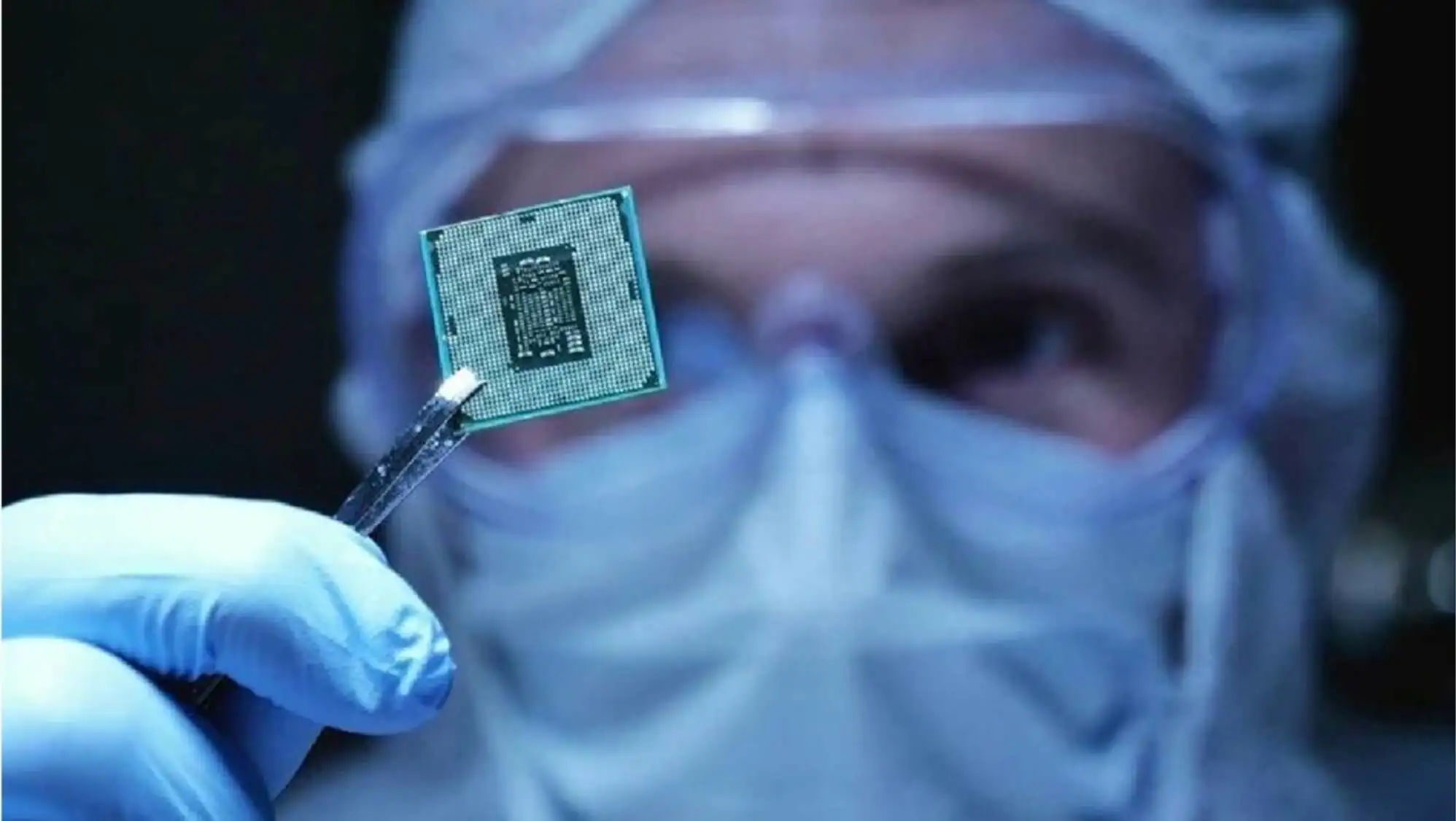 A person wearing a mask holding a microchip A person wearing a mask holding a microchip