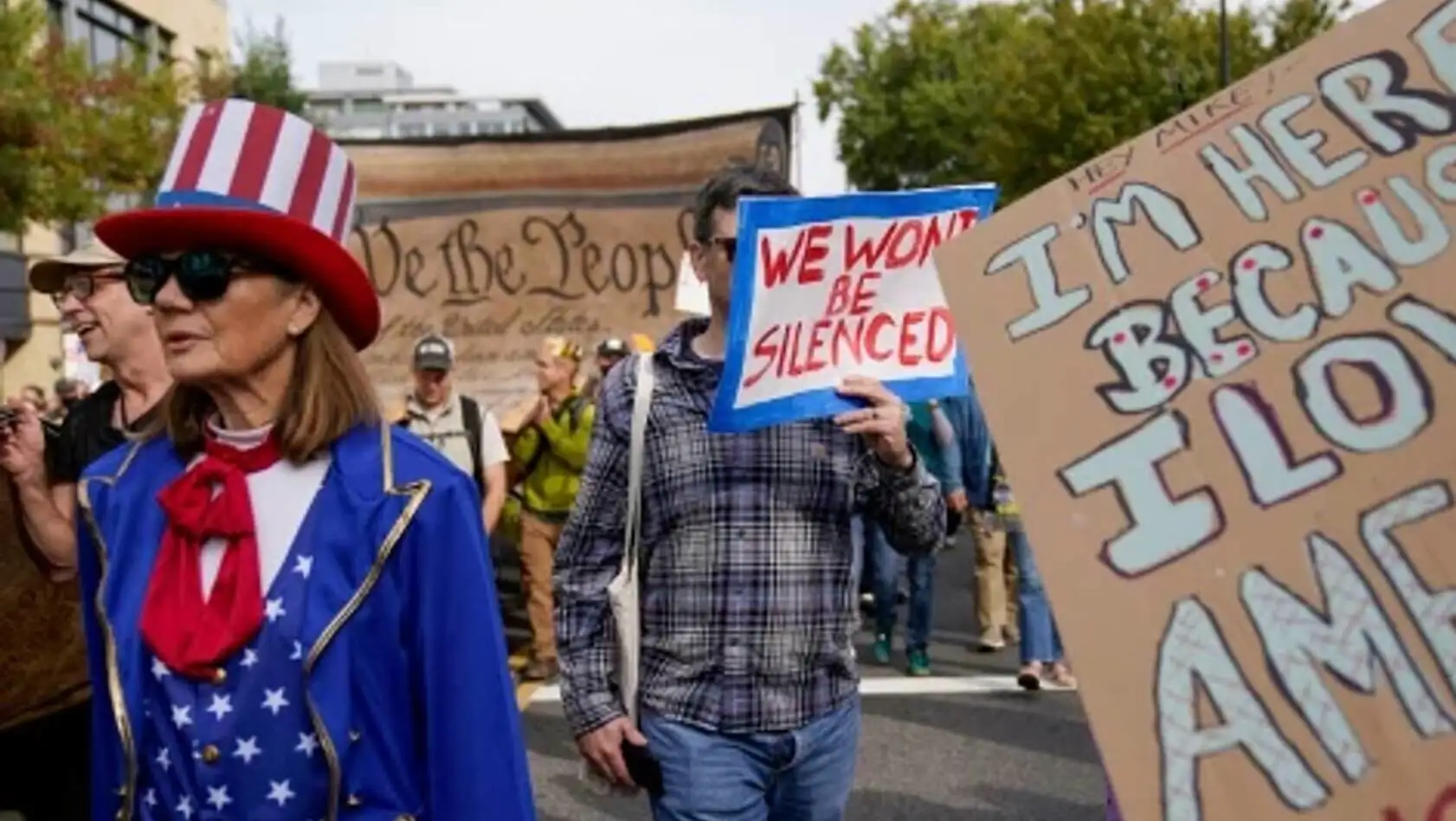 A group of people holding signs. A group of people holding signs.