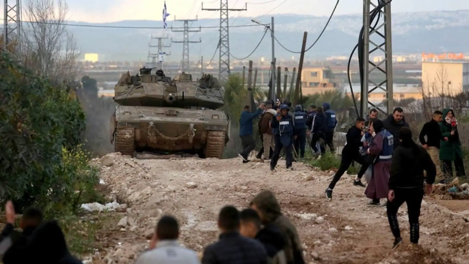 A military tank on a dirt road. A military tank on a dirt road.