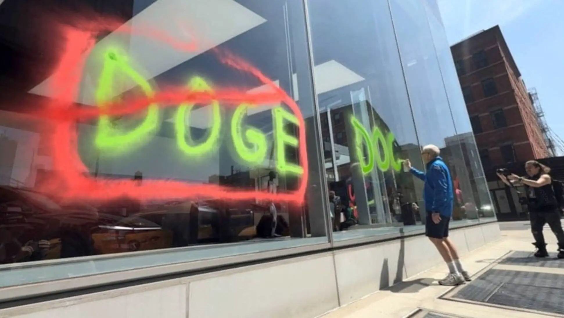 A person writing on a window.