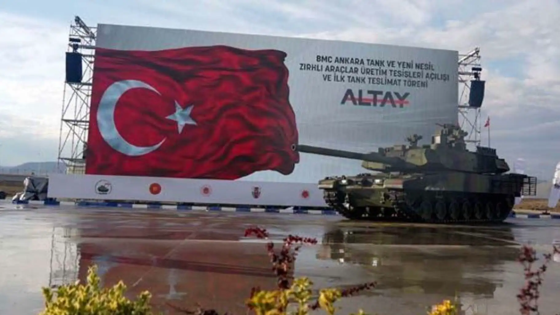 Bir tank, üzerinde bayrakla bir yolda. Bir tank, üzerinde bayrakla bir yolda.