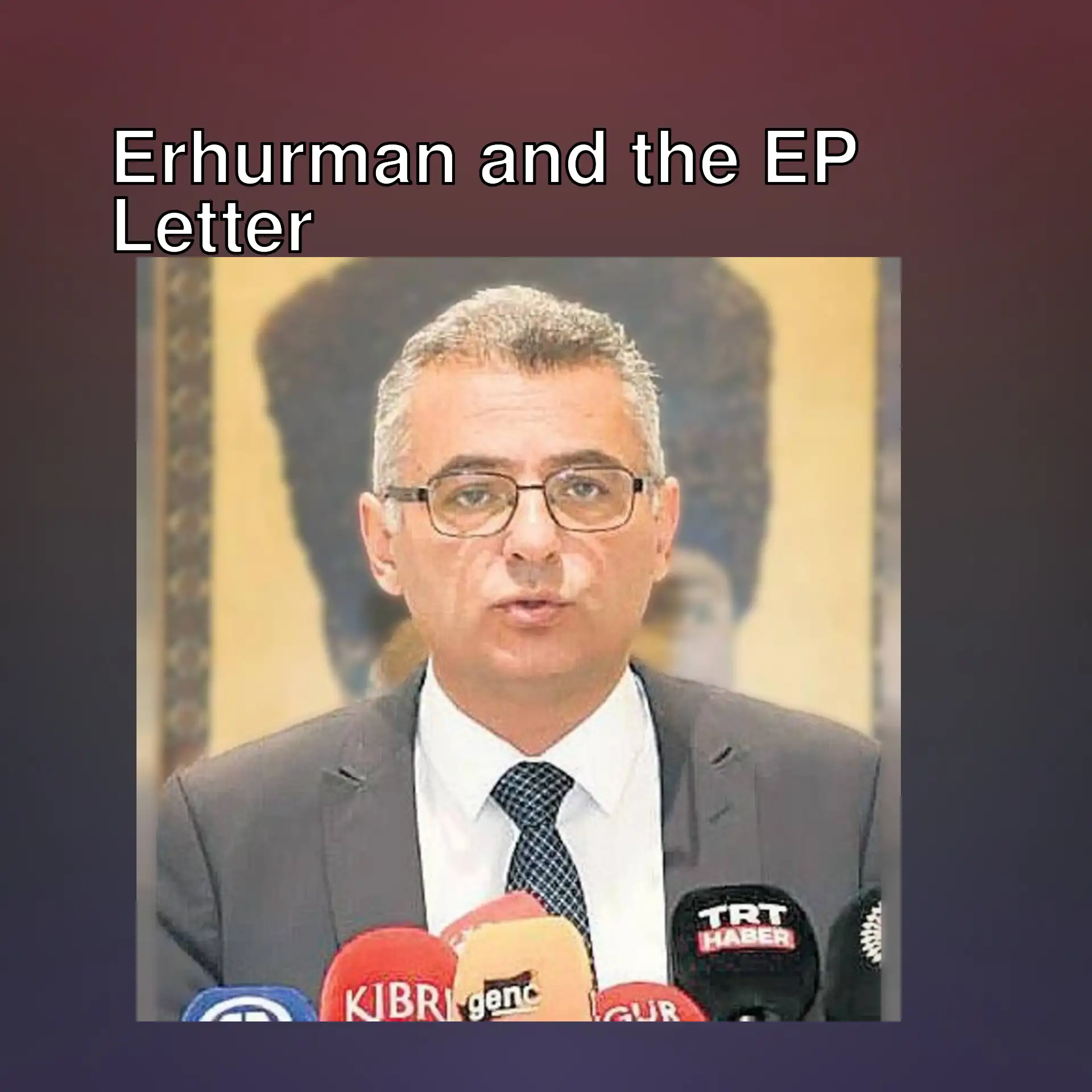 A man in a suit speaking into microphones. A man in a suit speaking into microphones.