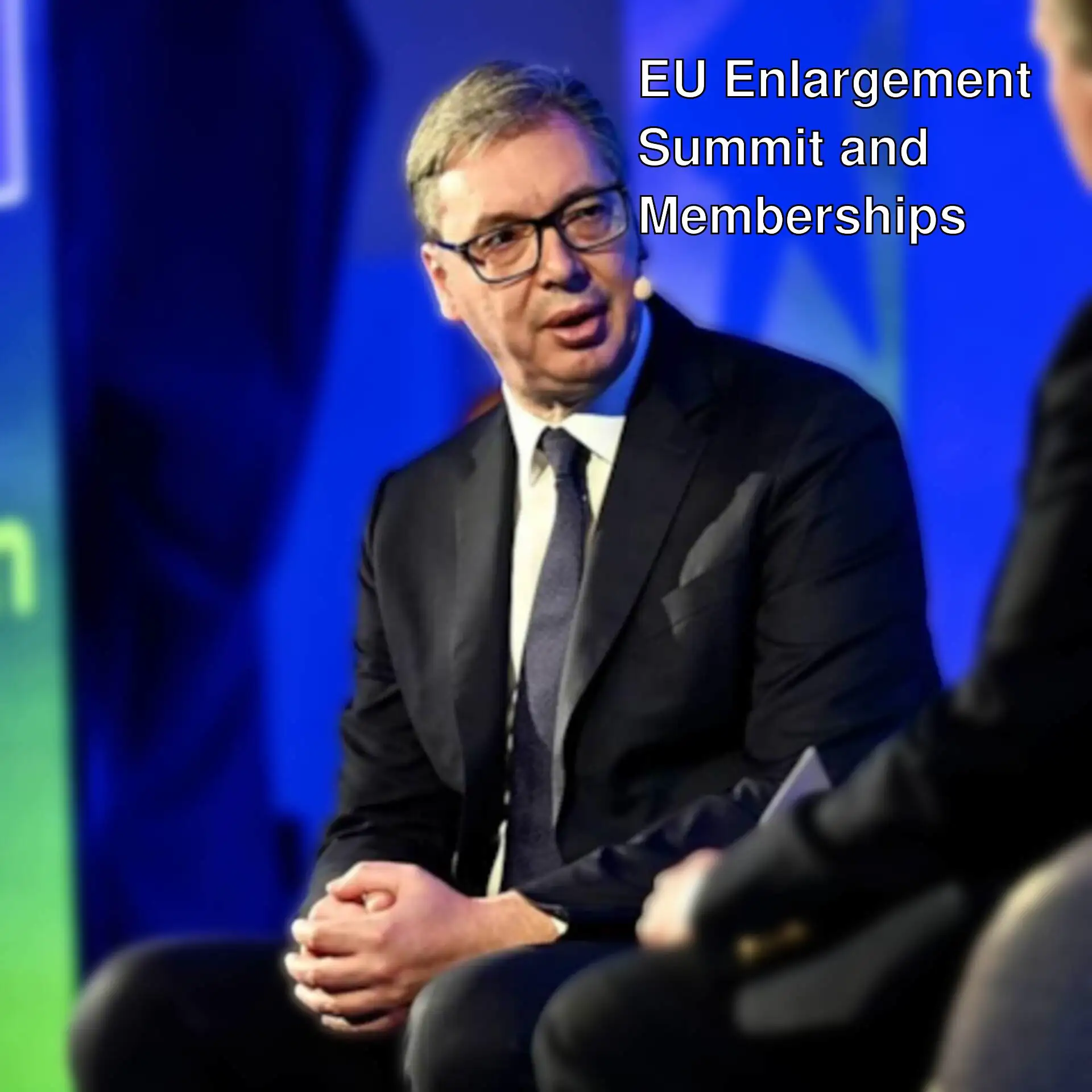 A man in a suit talking to another man.