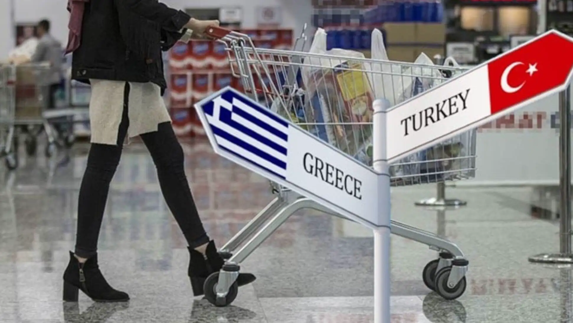 A woman pushing a shopping cart.