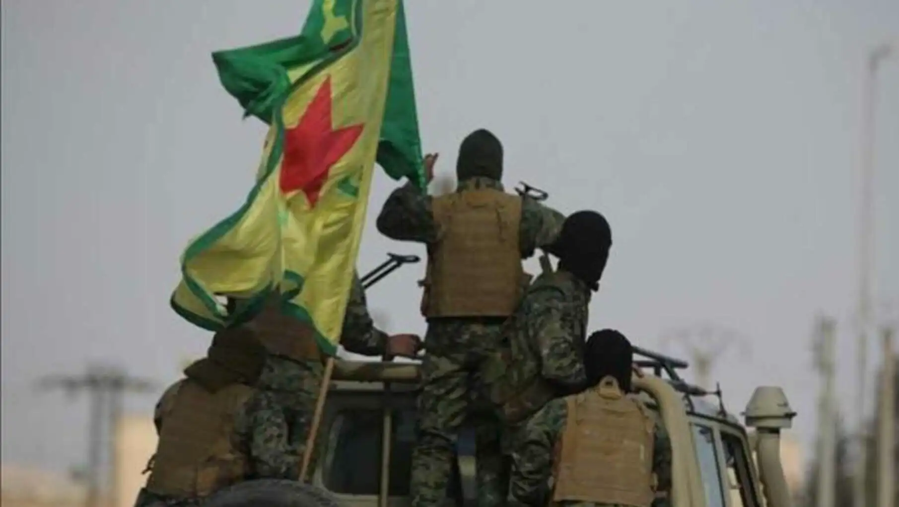 A group of soldiers holding a flag.
