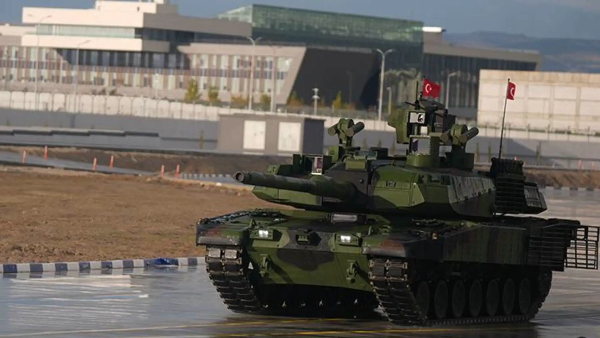 A military tank on a road. A military tank on a road.