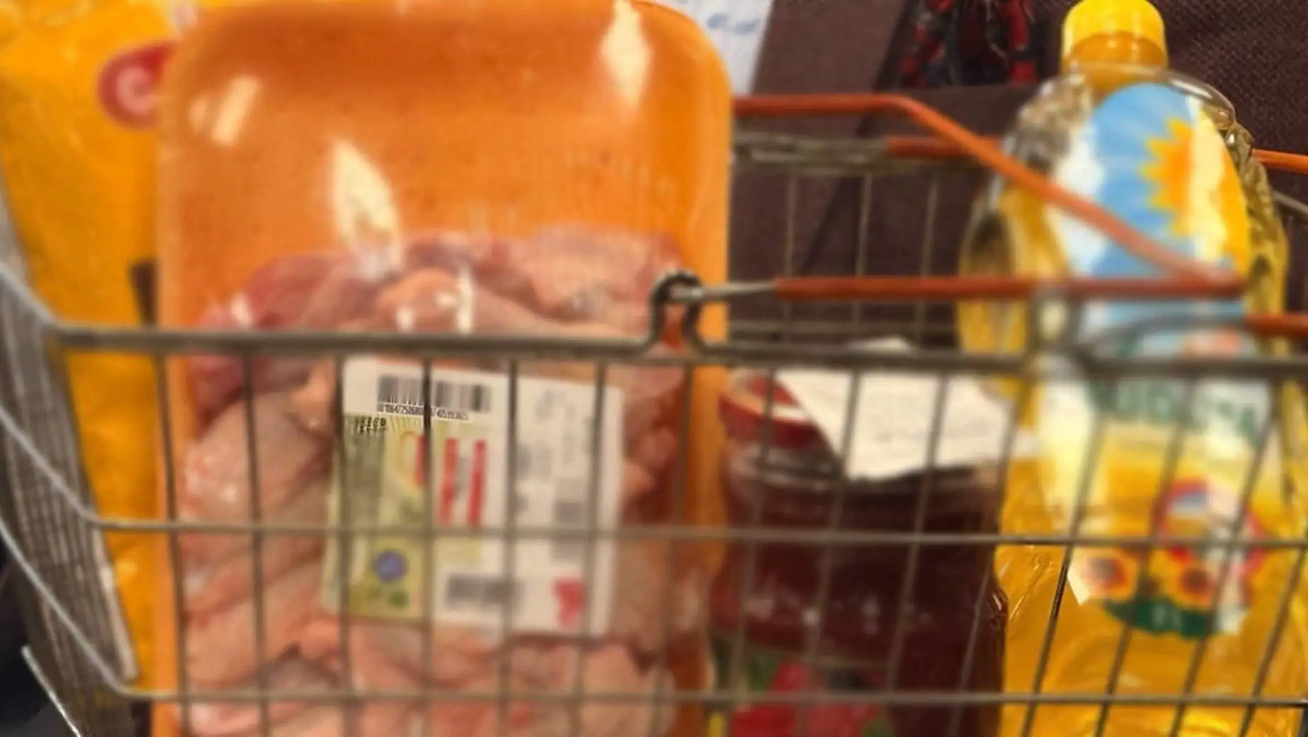 A shopping cart with food in it. A shopping cart with food in it.