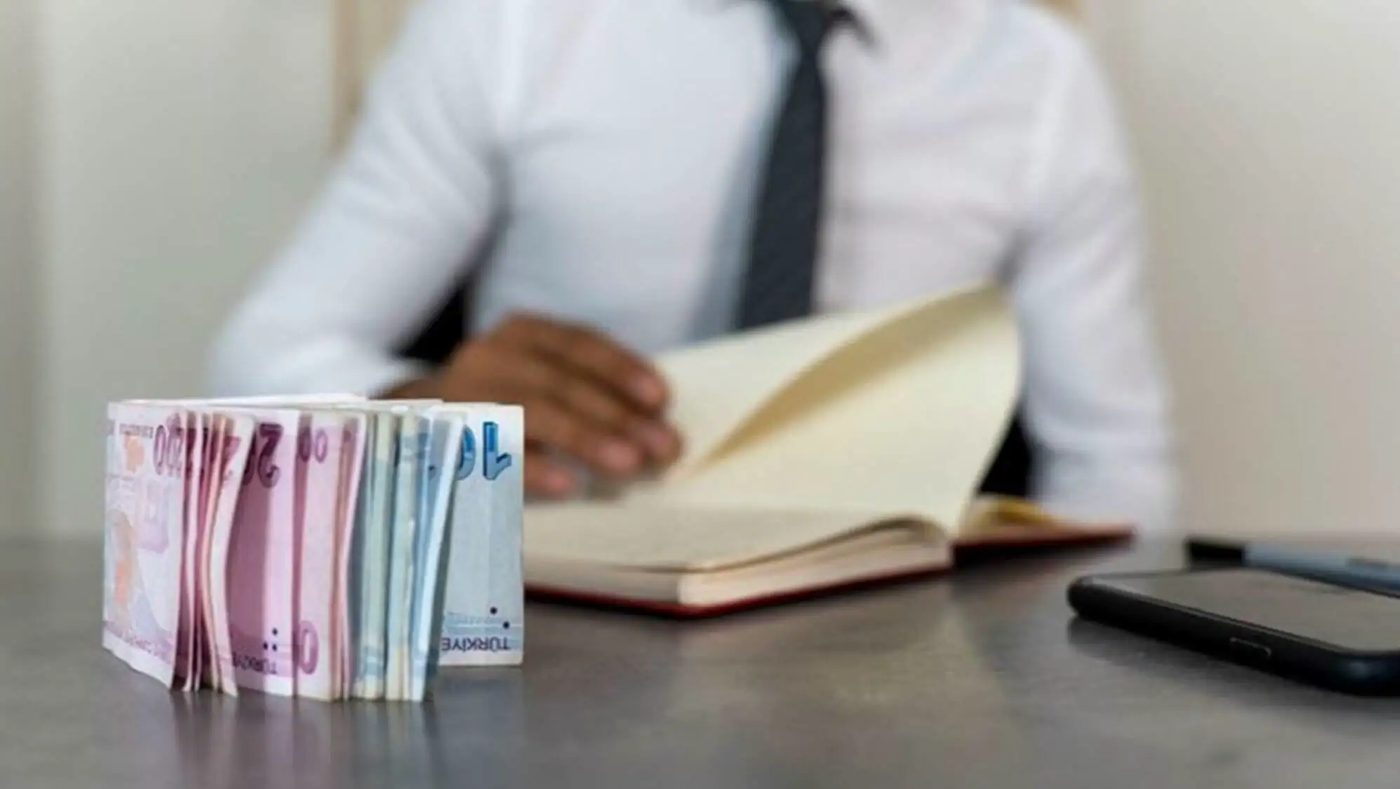 A stack of money on a table. A stack of money on a table.