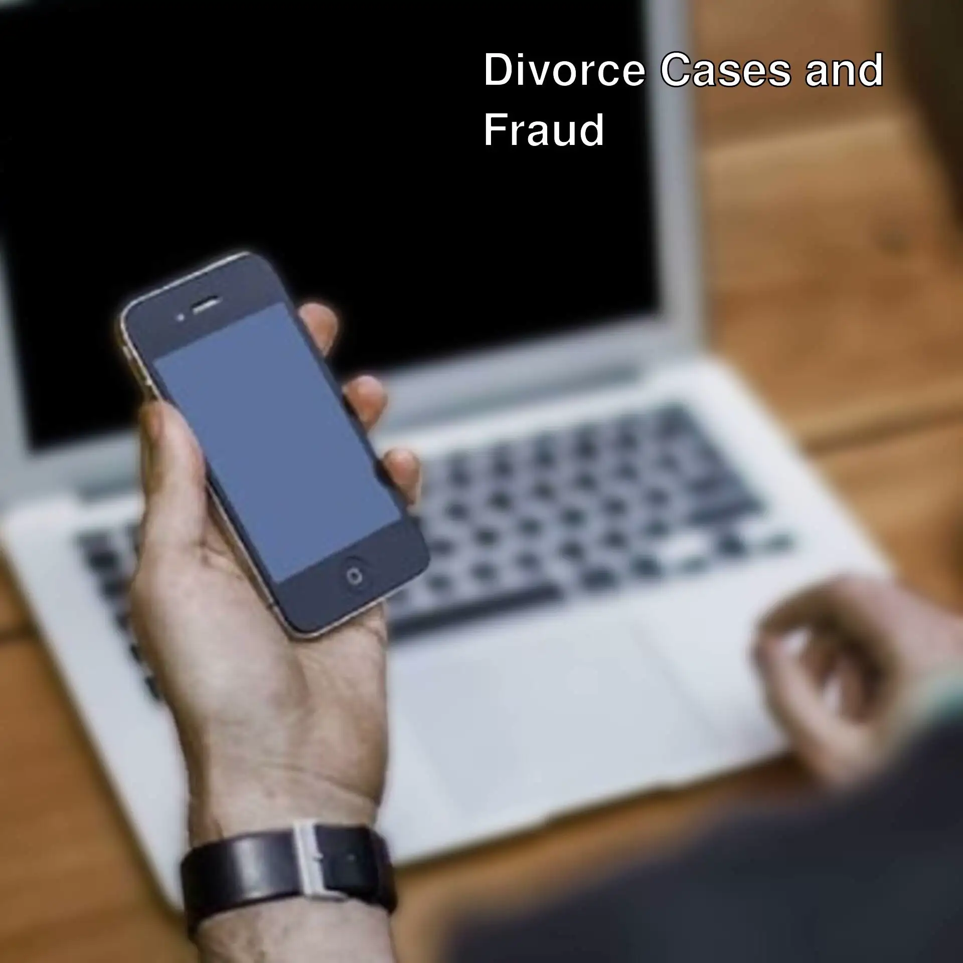 A person holding a phone in front of a laptop. A person holding a phone in front of a laptop.
