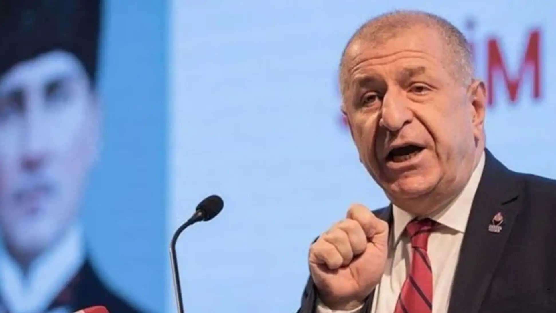 Ümit Özdağ speaking into a microphone.