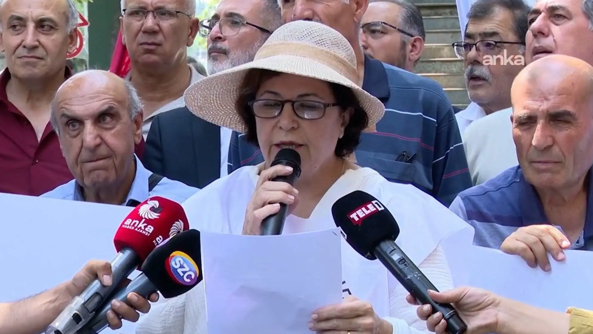 A woman speaking into microphones. A woman speaking into microphones.