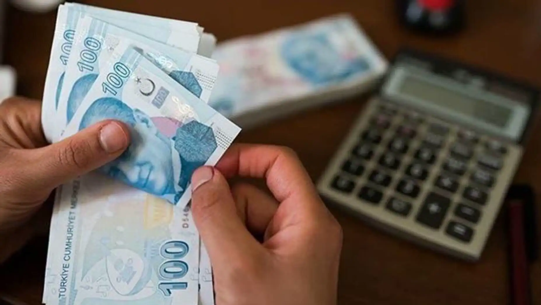A hand holding a stack of money. A hand holding a stack of money.
