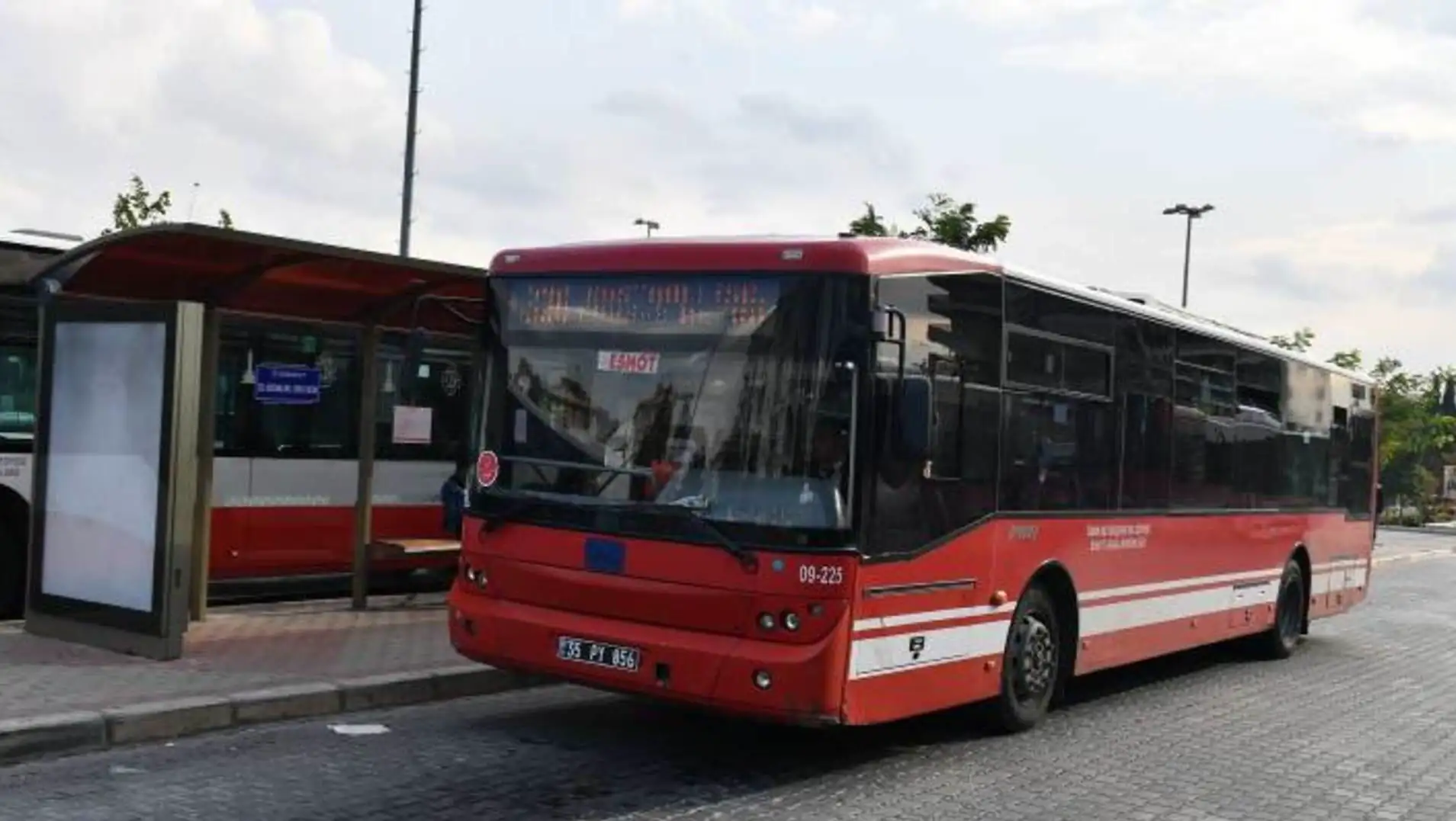 A red bus on a street in İzmir. A red bus on a street in İzmir.