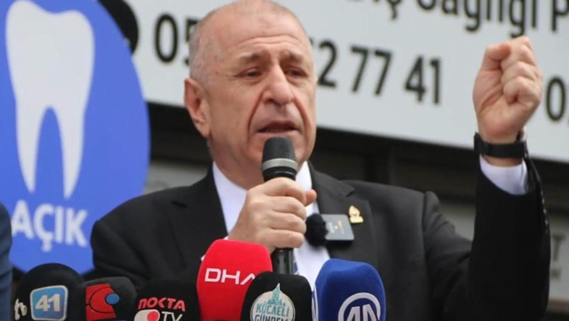 Ümit Özdağ speaking into a microphone. Ümit Özdağ speaking into a microphone.