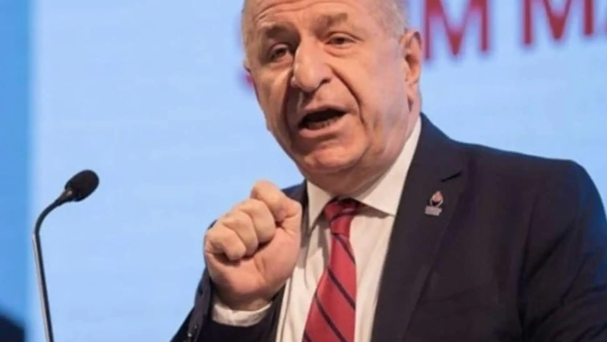 Ümit Özdağ speaking into a microphone. Ümit Özdağ speaking into a microphone.