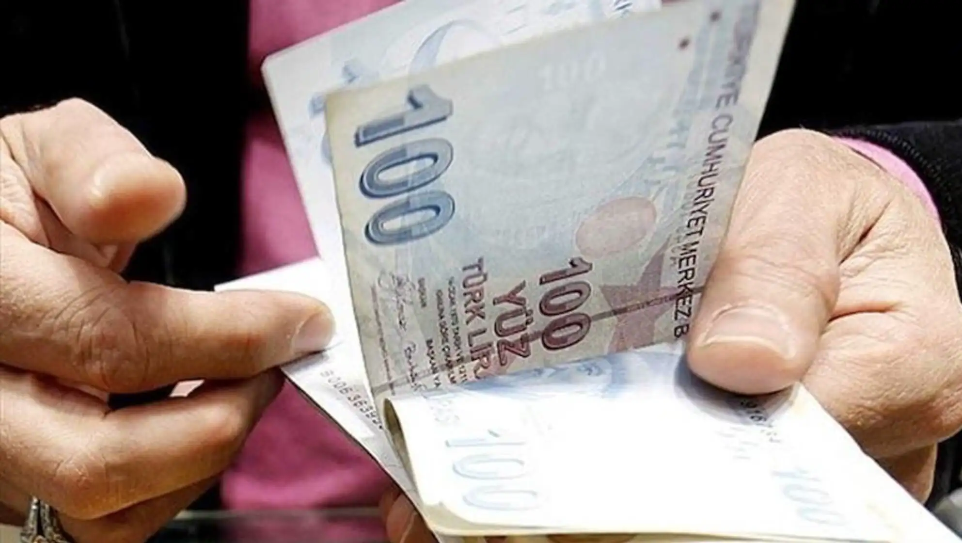 A person holding a stack of money. A person holding a stack of money.