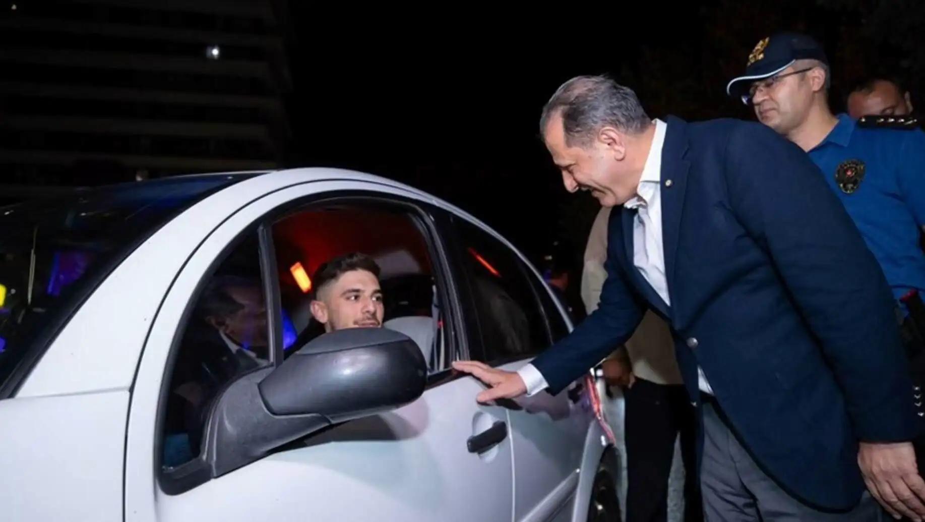 A man pointing at a car window. A man pointing at a car window.