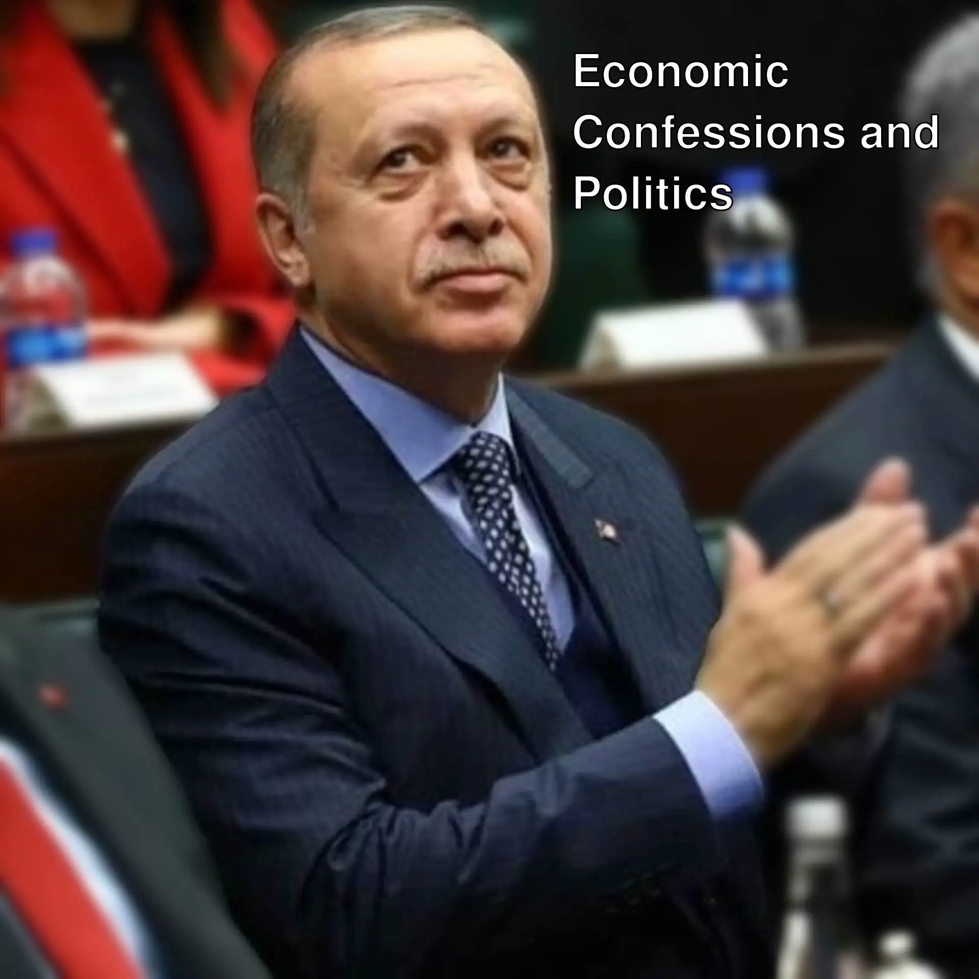 Hayati Yazıcı, a man in a suit clapping while speaking about the economy. Hayati Yazıcı, a man in a suit clapping while speaking about the economy.