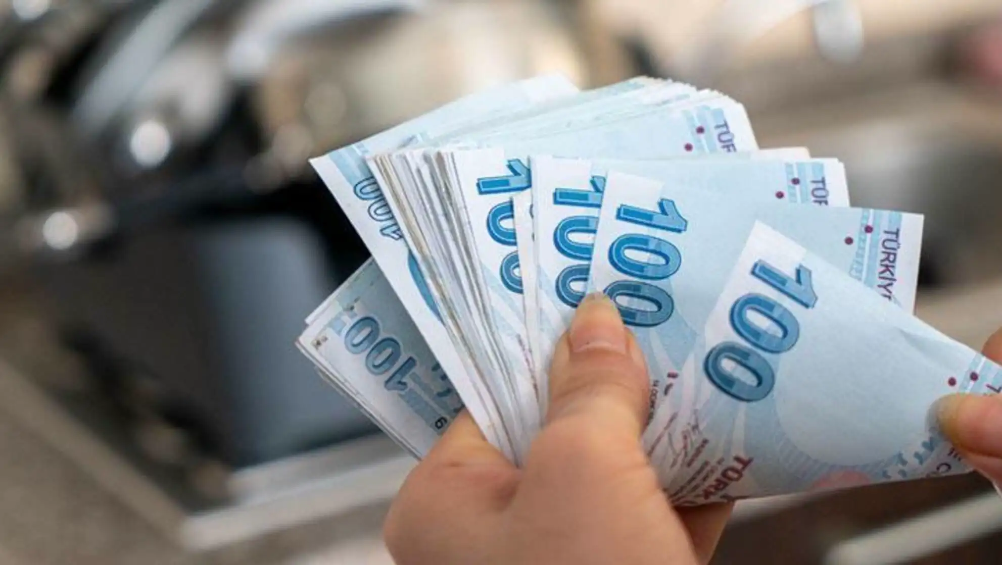 A person holding a stack of paper money.