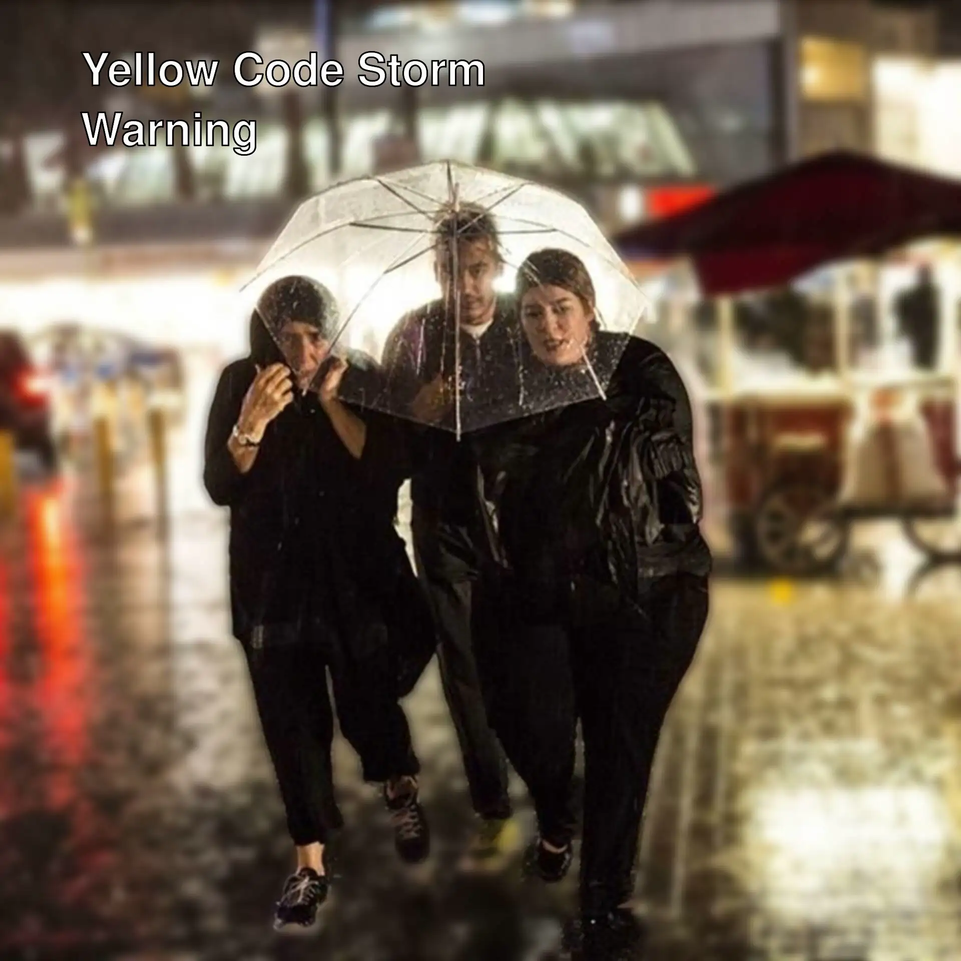 A group of people under an umbrella
