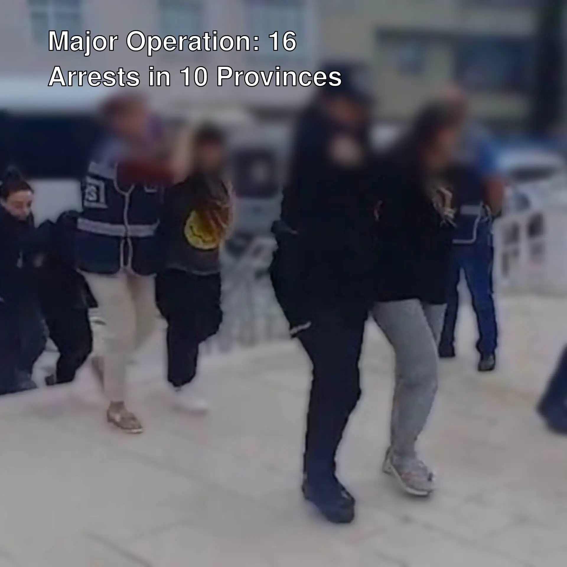 A group of people walking on a sidewalk. A group of people walking on a sidewalk.