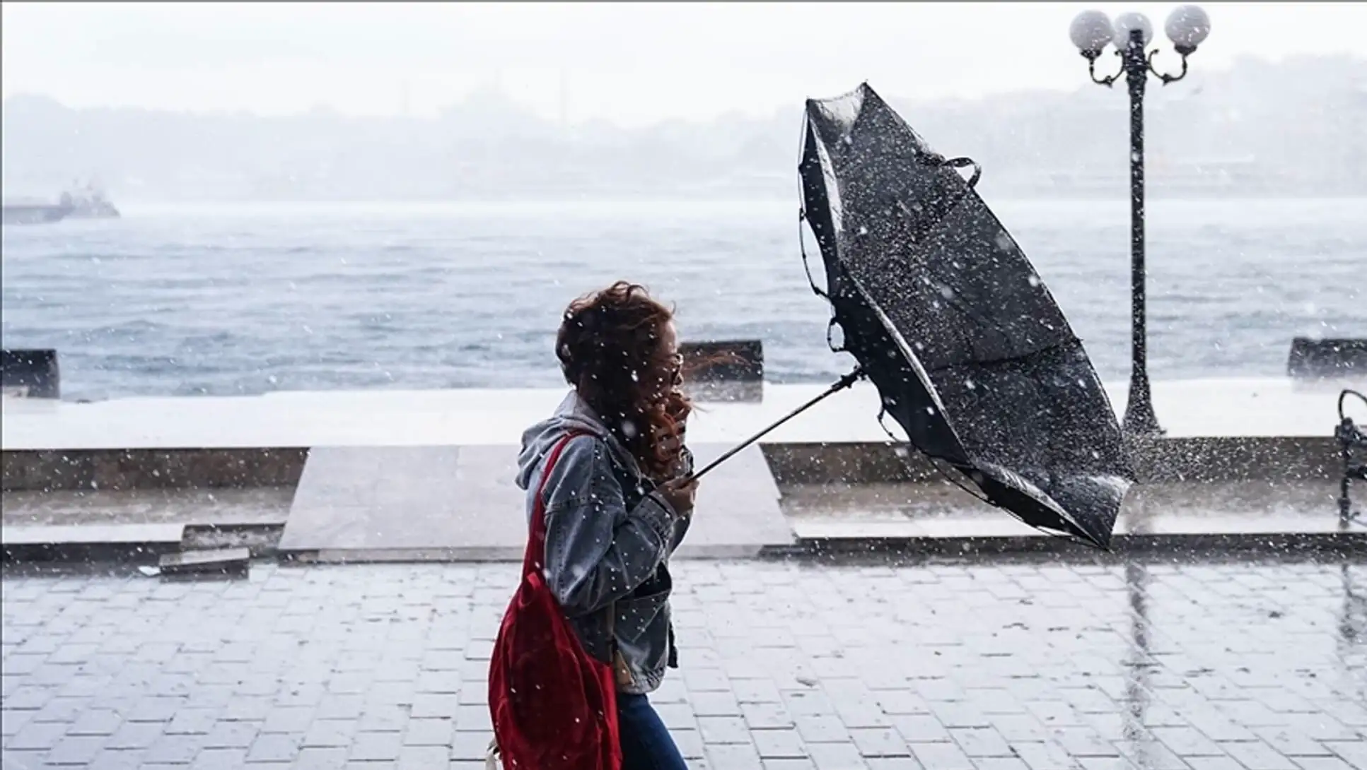 A woman holding an umbrella in the rain