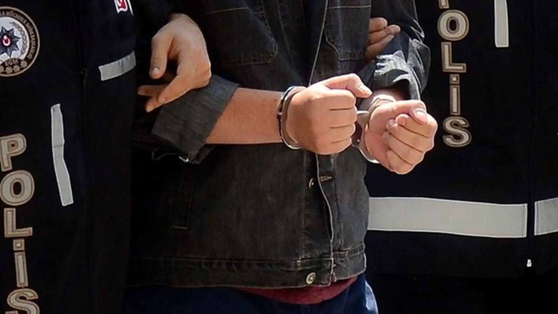 An individual in handcuffs. Suspects arrested during the operation. An individual in handcuffs. Suspects arrested during the operation.