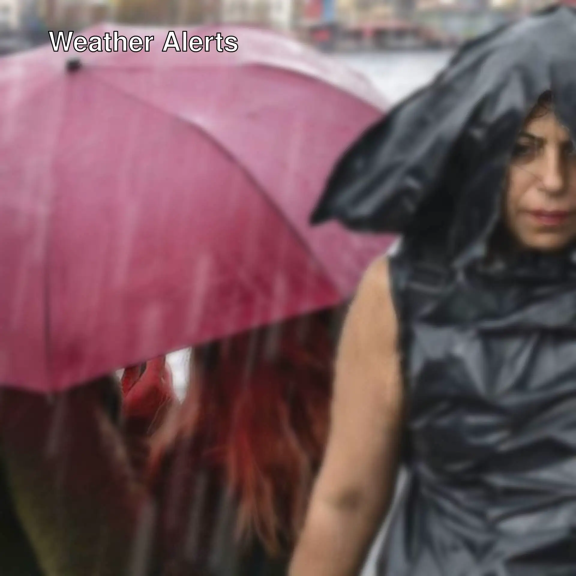 A woman in a raincoat with a pink umbrella.