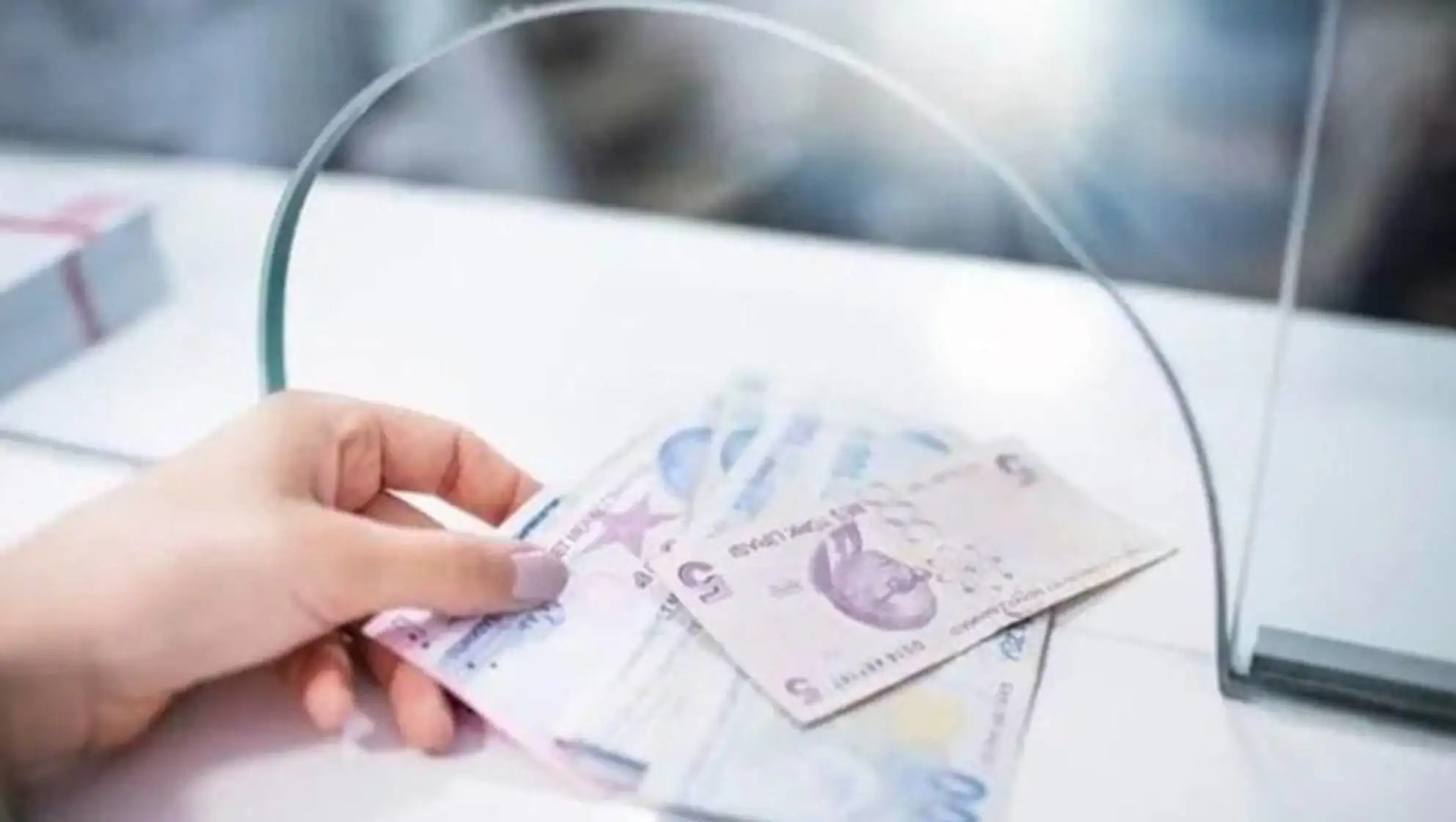 A hand holding money.