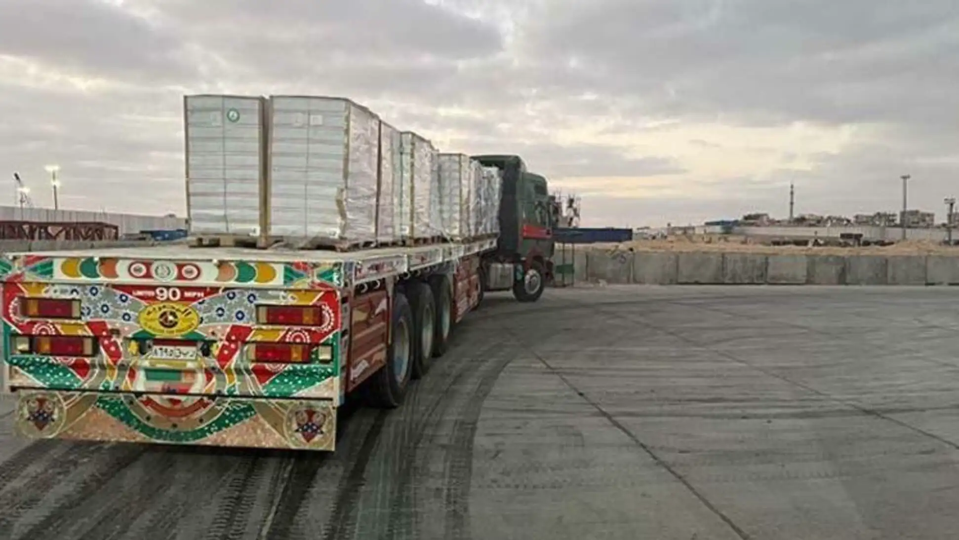 A truck with a painted flatbed trailer. A truck with a painted flatbed trailer.