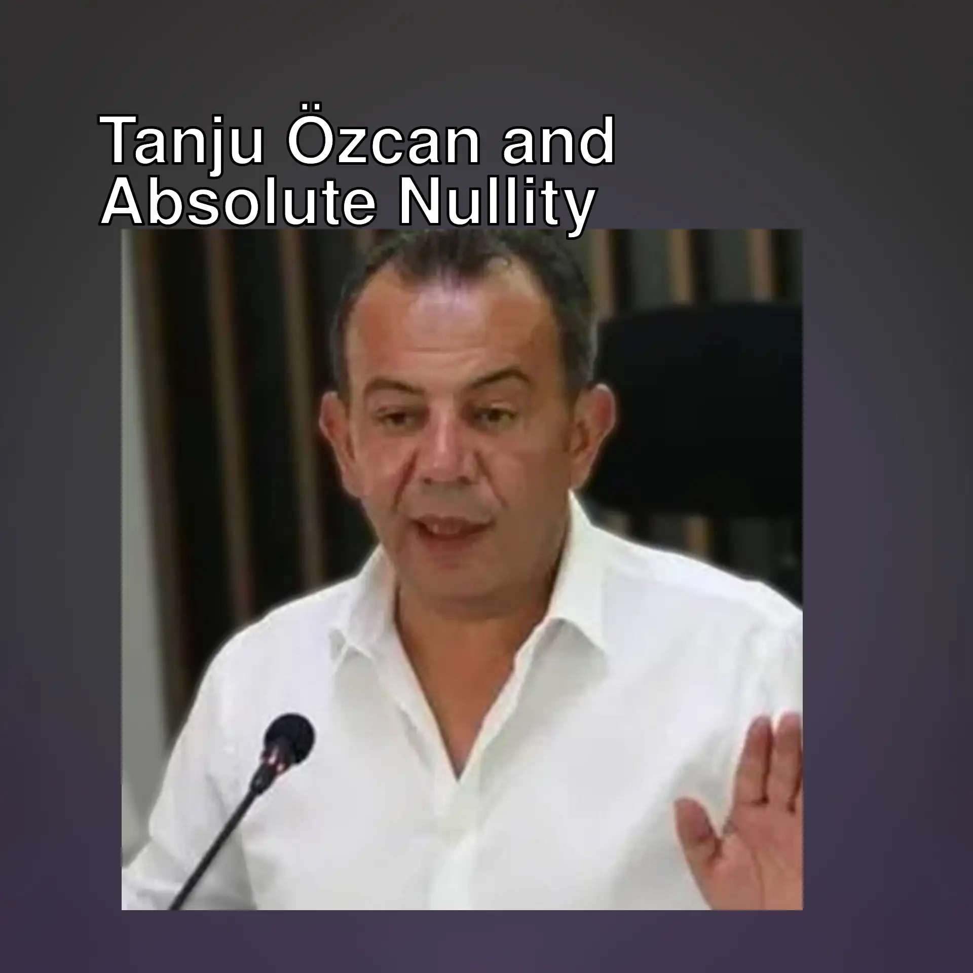 Tanju Özcan speaking in a white shirt. Tanju Özcan speaking in a white shirt.