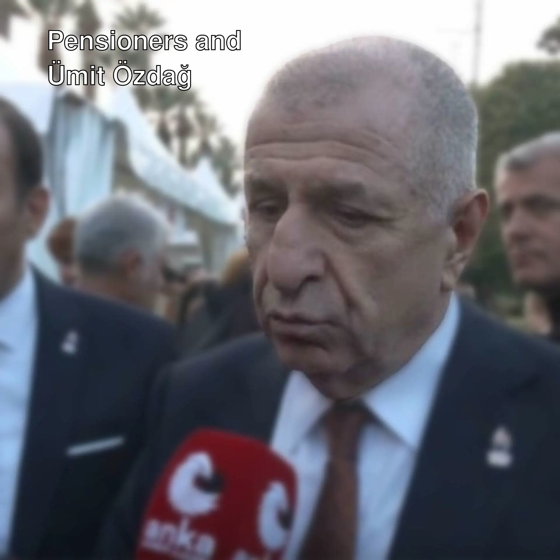Ümit Özdağ speaking into a microphone. Ümit Özdağ speaking into a microphone.