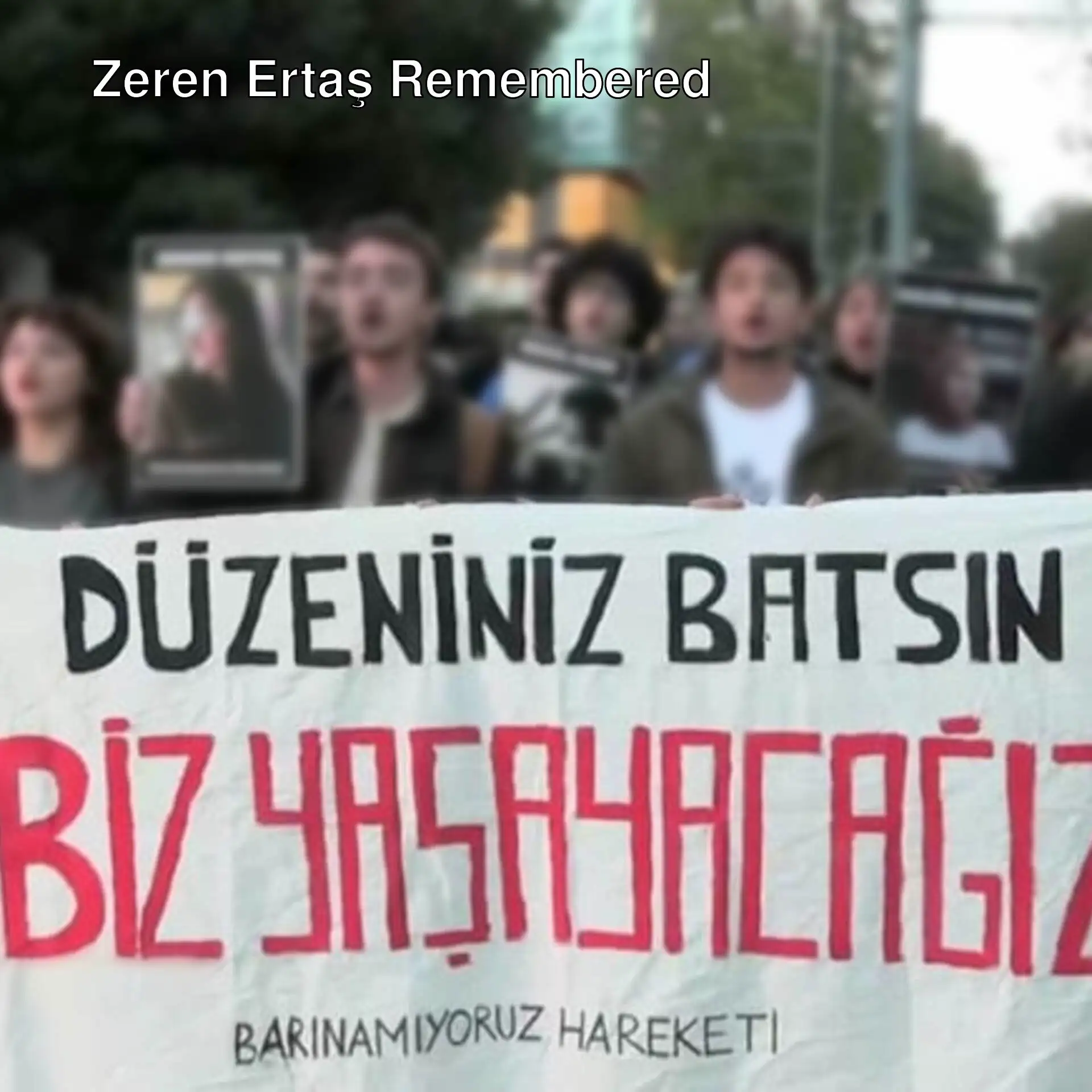 A group of people holding signs. A group of people holding signs.