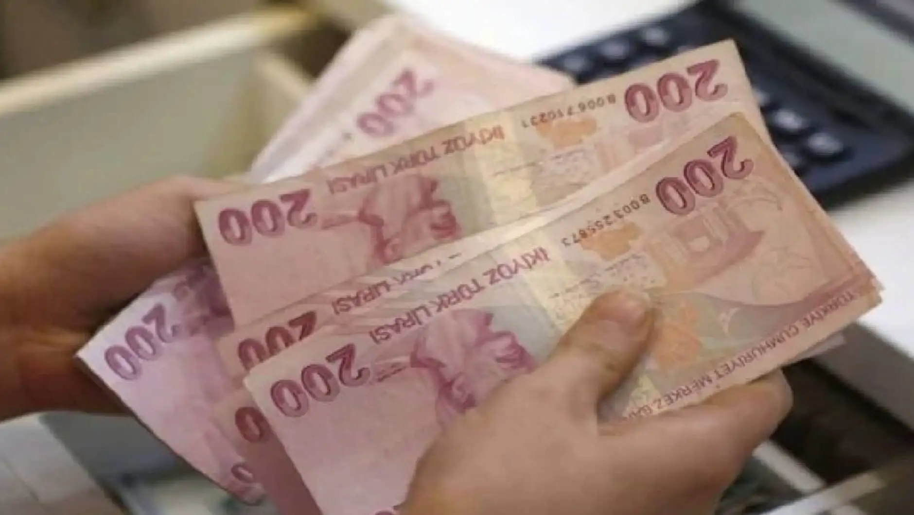 A person holding a stack of money. A person holding a stack of money.