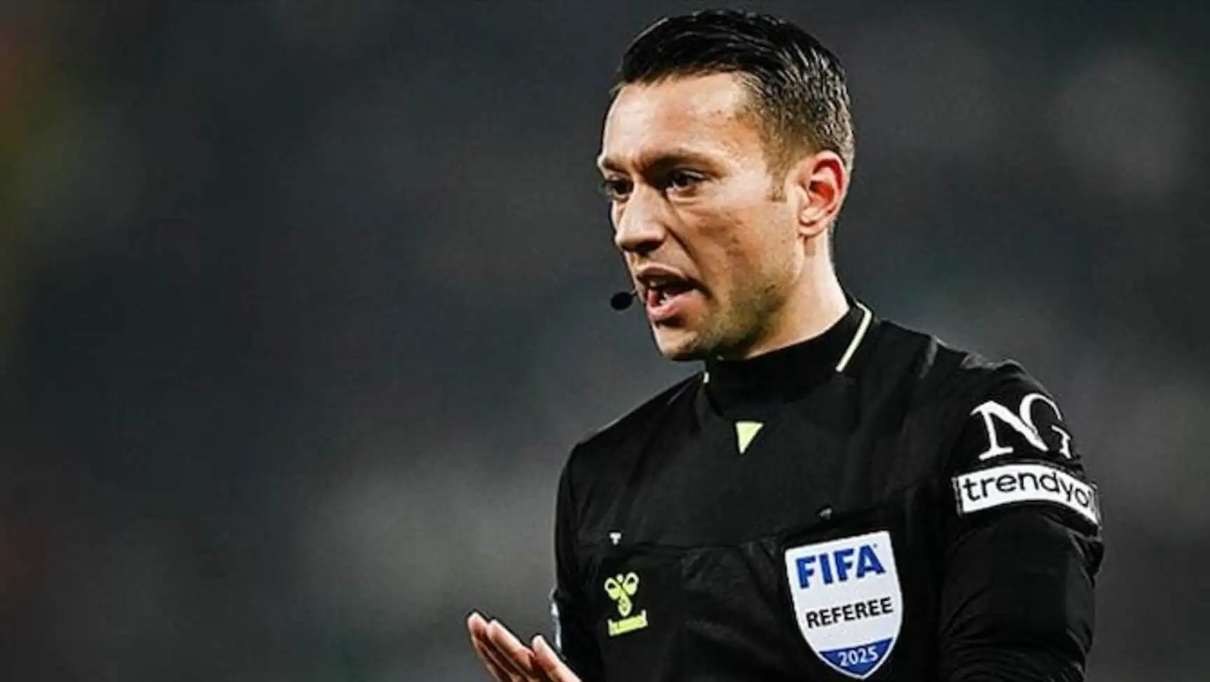 Zorbay Küçük in a black uniform.