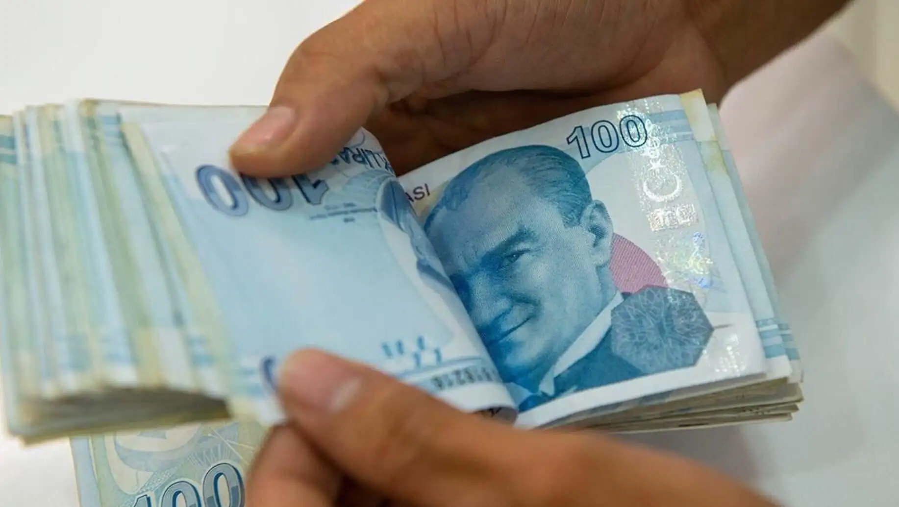 A hand holding money. A hand holding money.