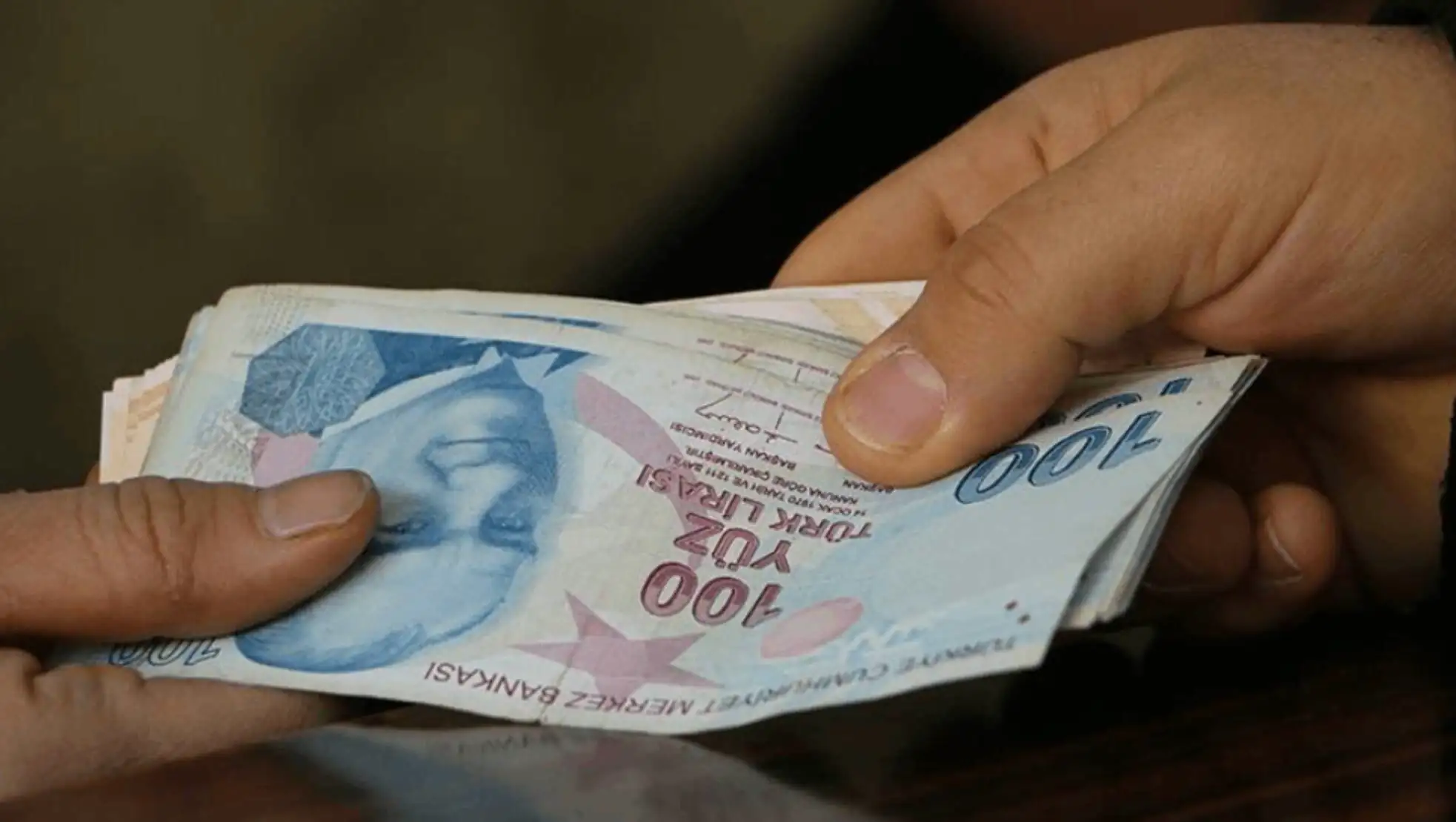 Bir kişi para torbası tutuyor.