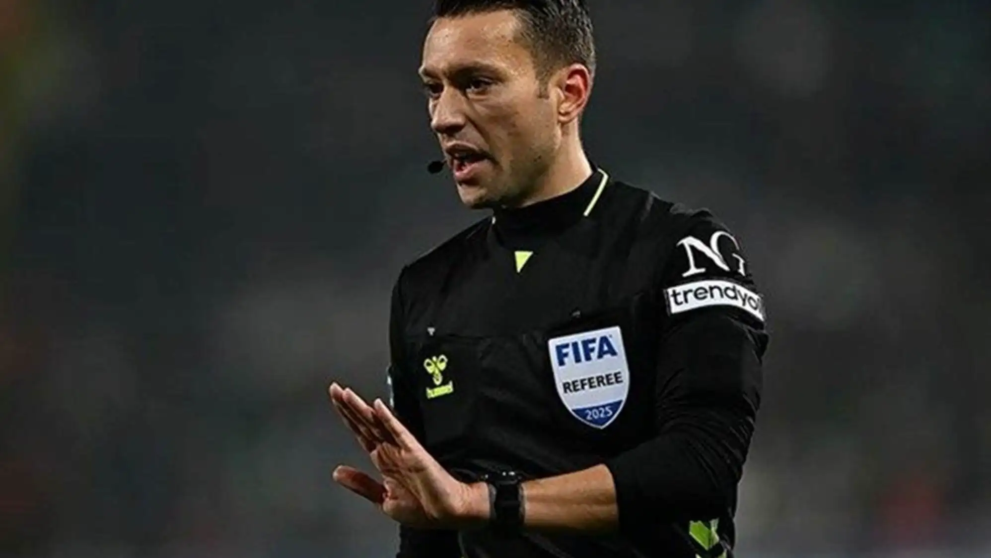 A man in a black uniform. A man in a black uniform.