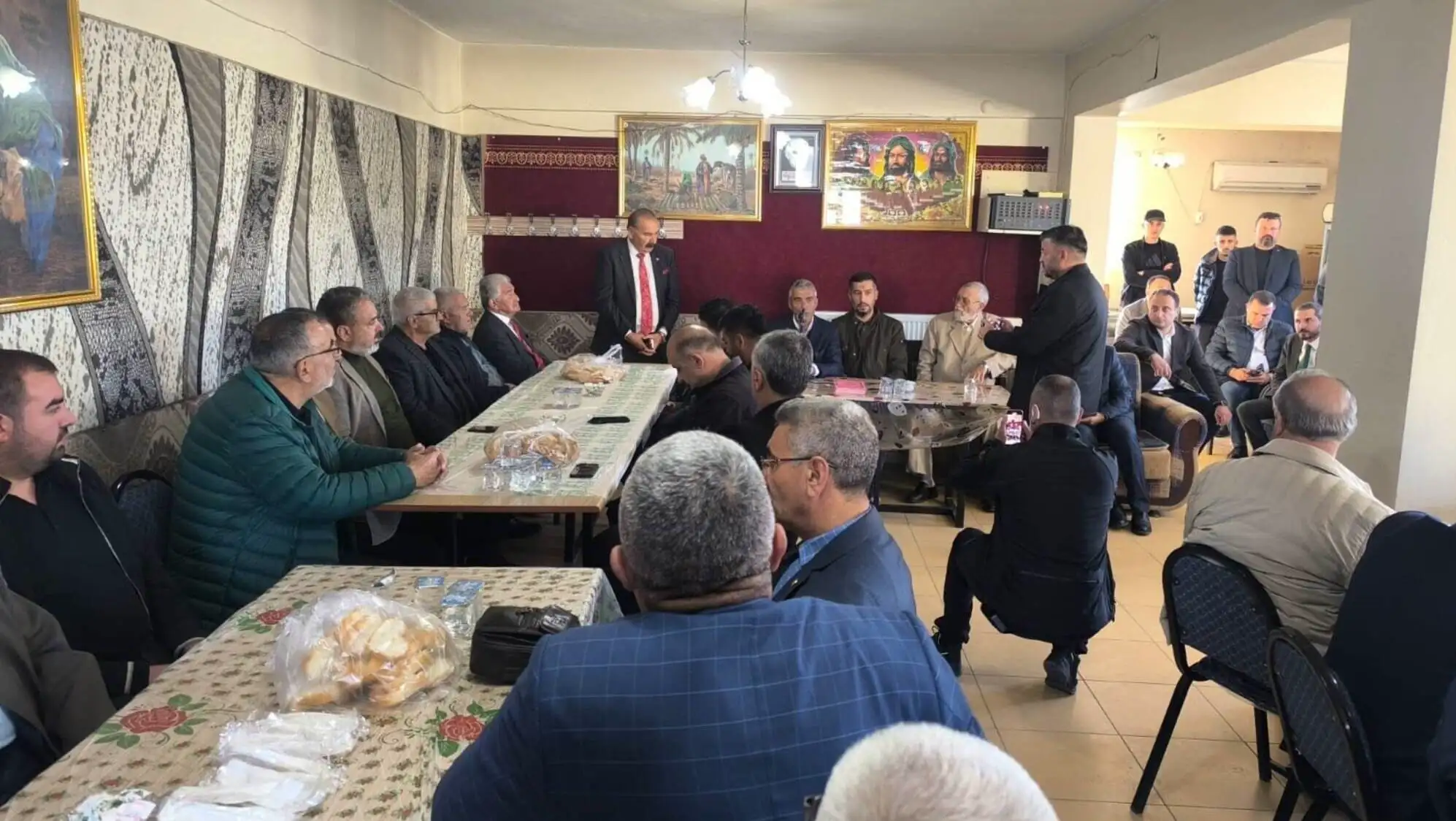 A group of people sitting around a table. A group of people sitting around a table.