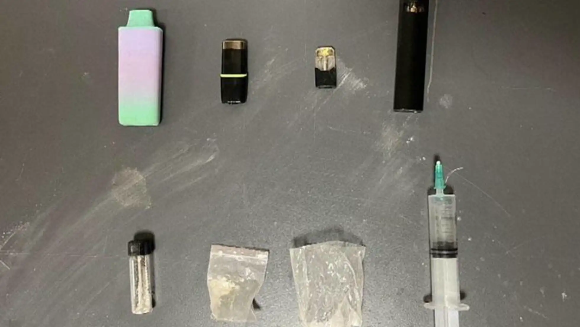 A group of objects related to drug use on a table.