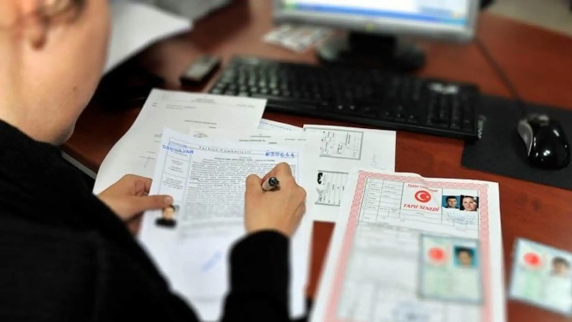 A person signing a document.