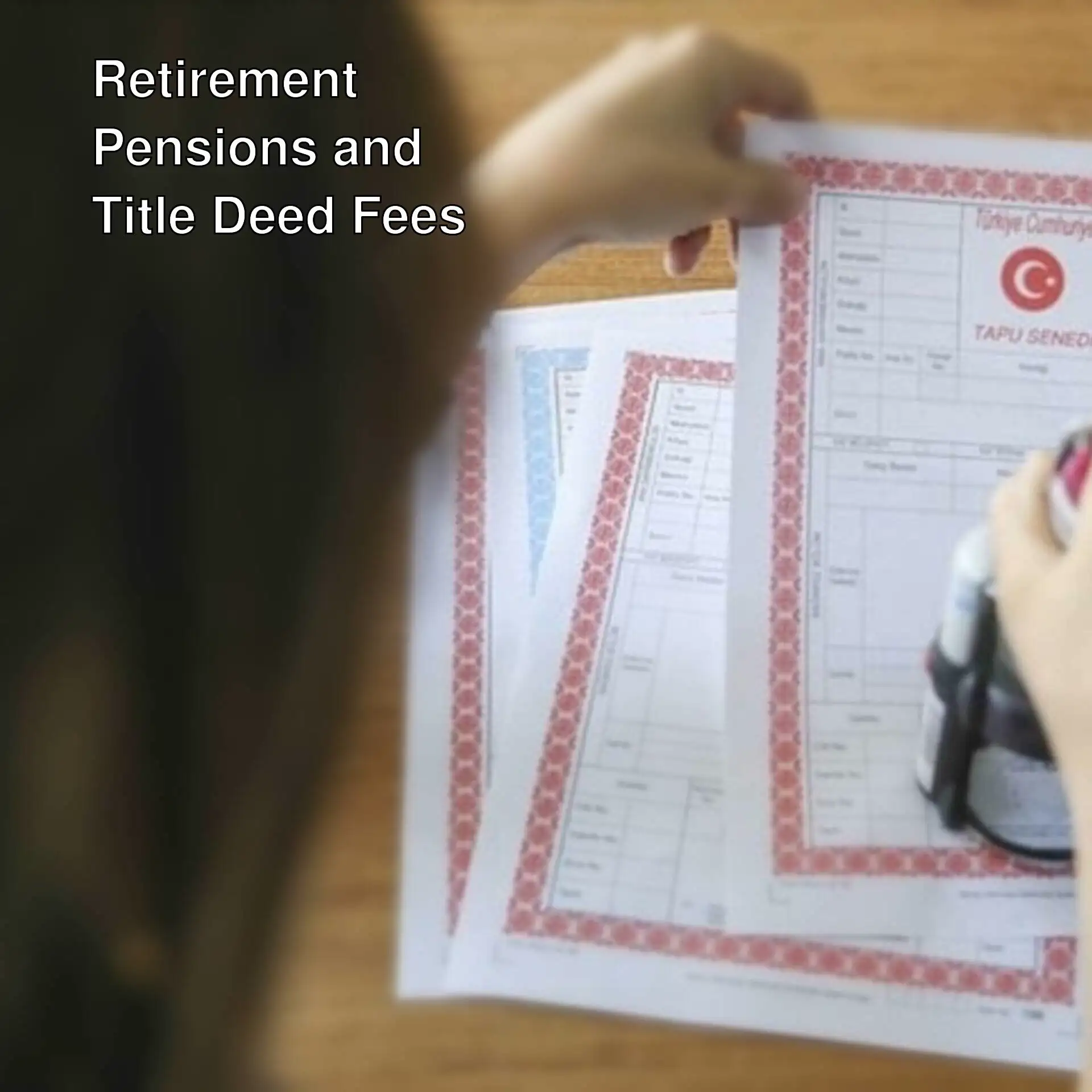 A person holding a stamp on a paper.