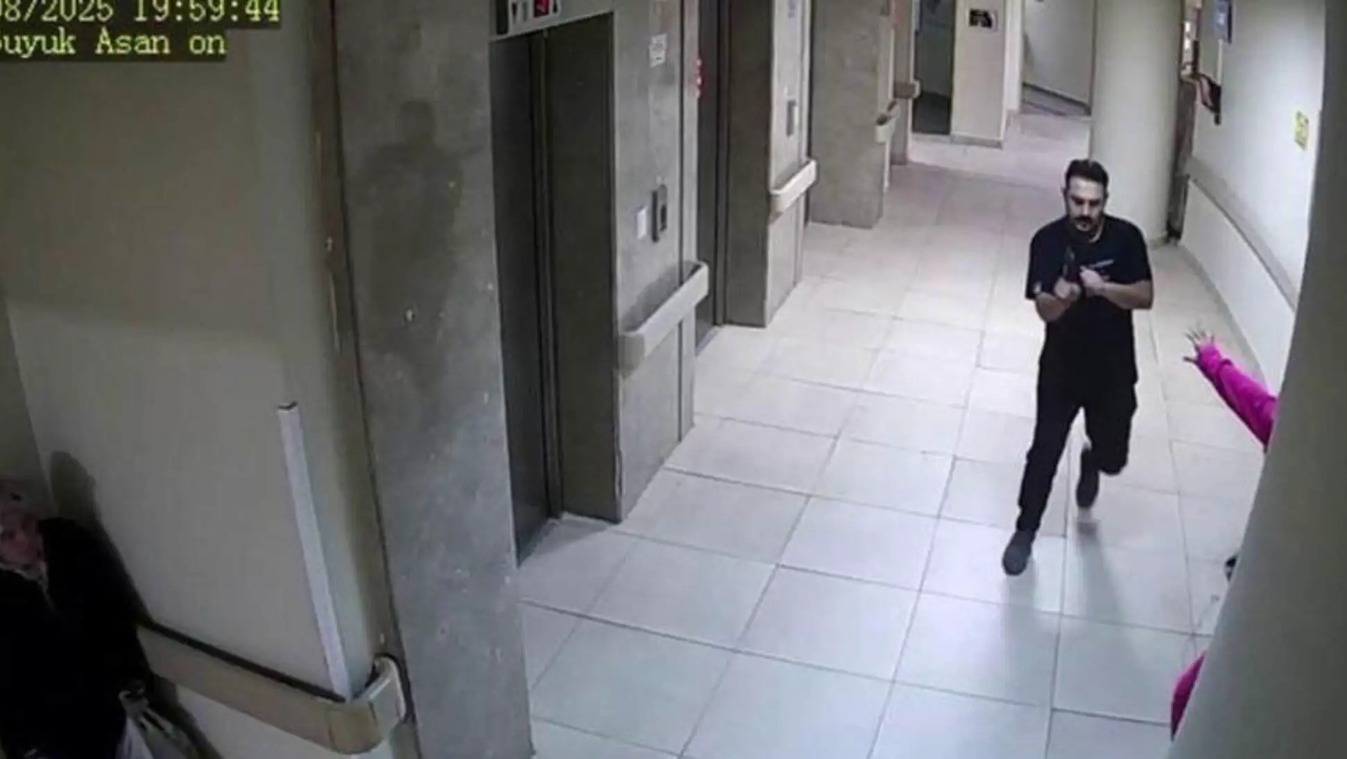 A man walking in a hospital corridor.