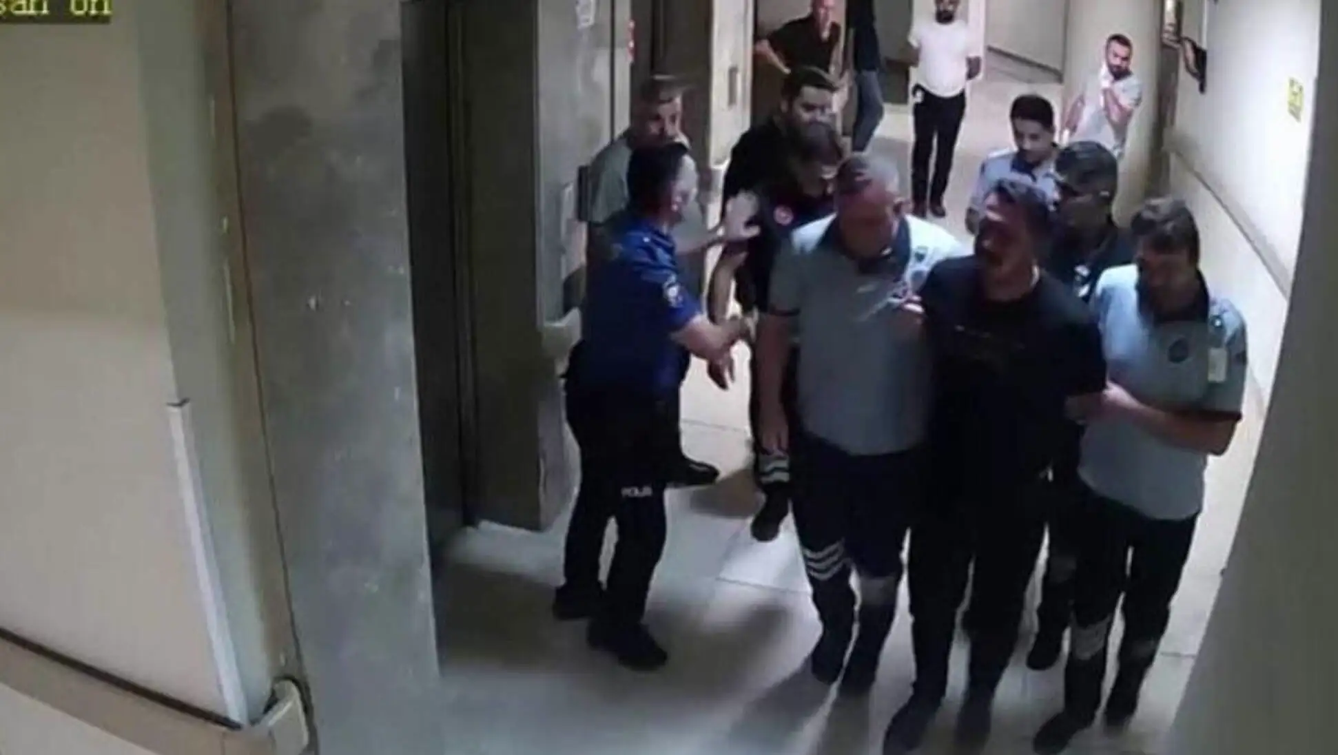 A group of people in a hospital corridor.